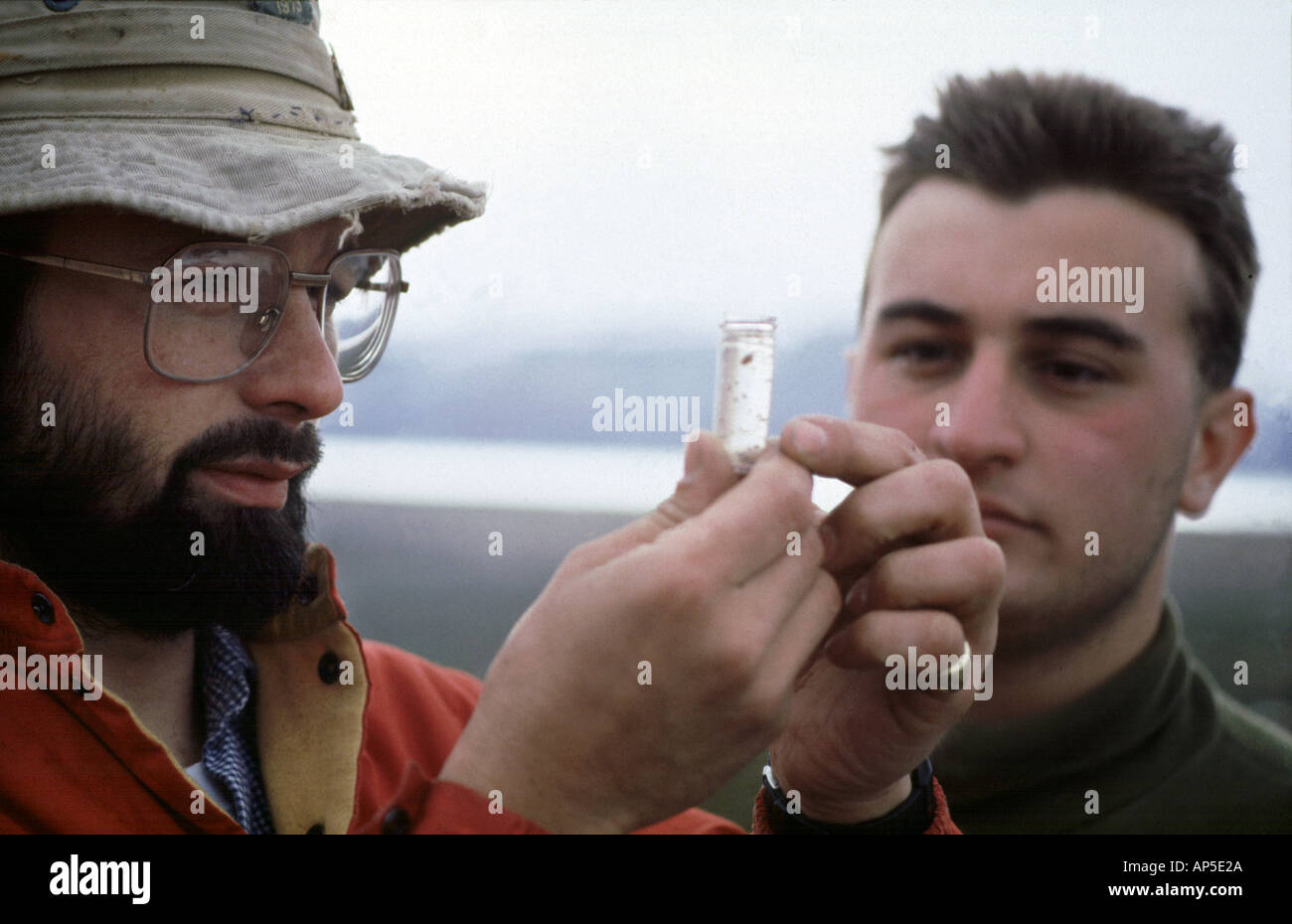 Scientist examins water sample Spitsbergen Stock Photo