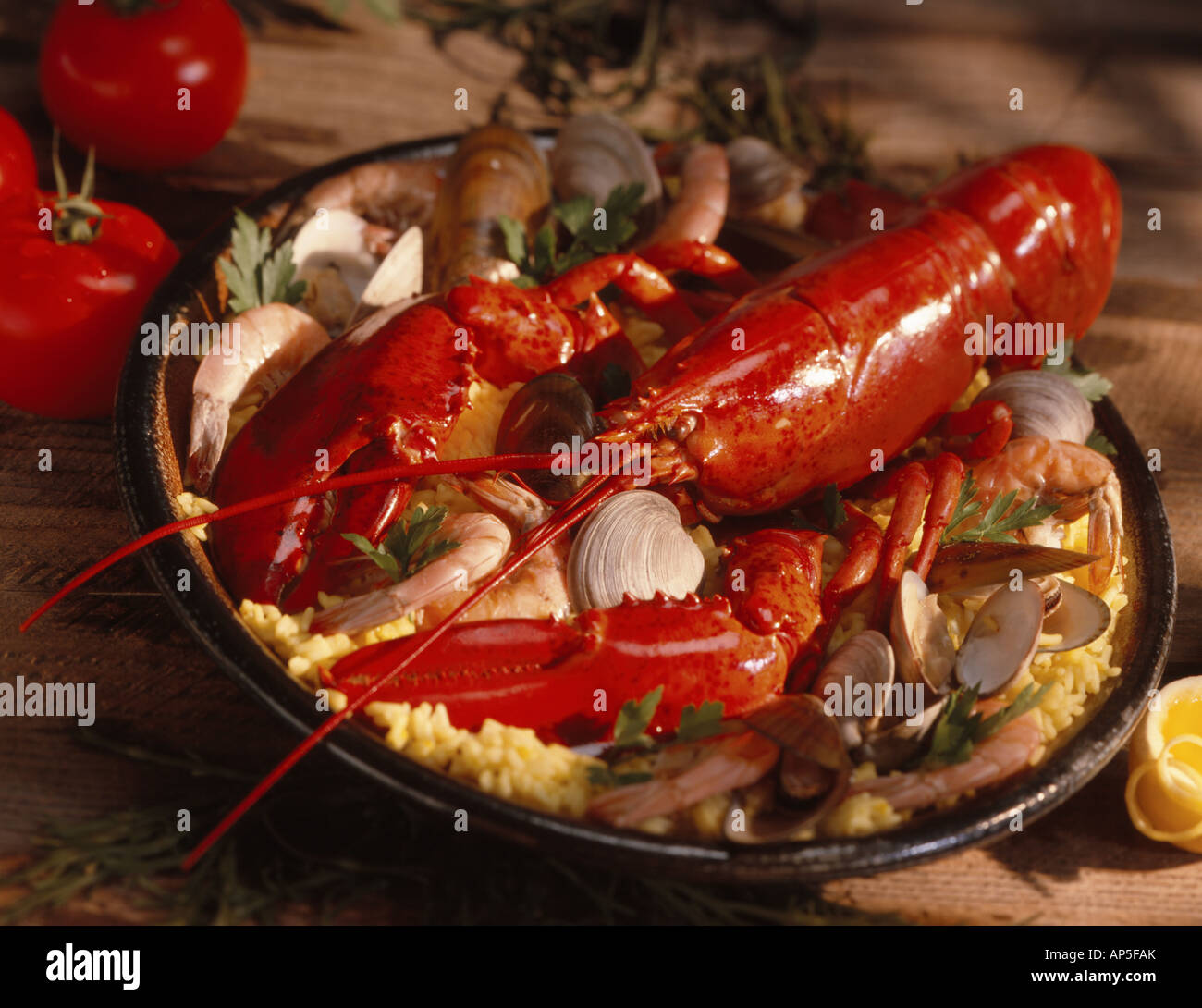 Lobster Paella with Lobster shrimps clams mussels and yellow saffron rice Stock Photo