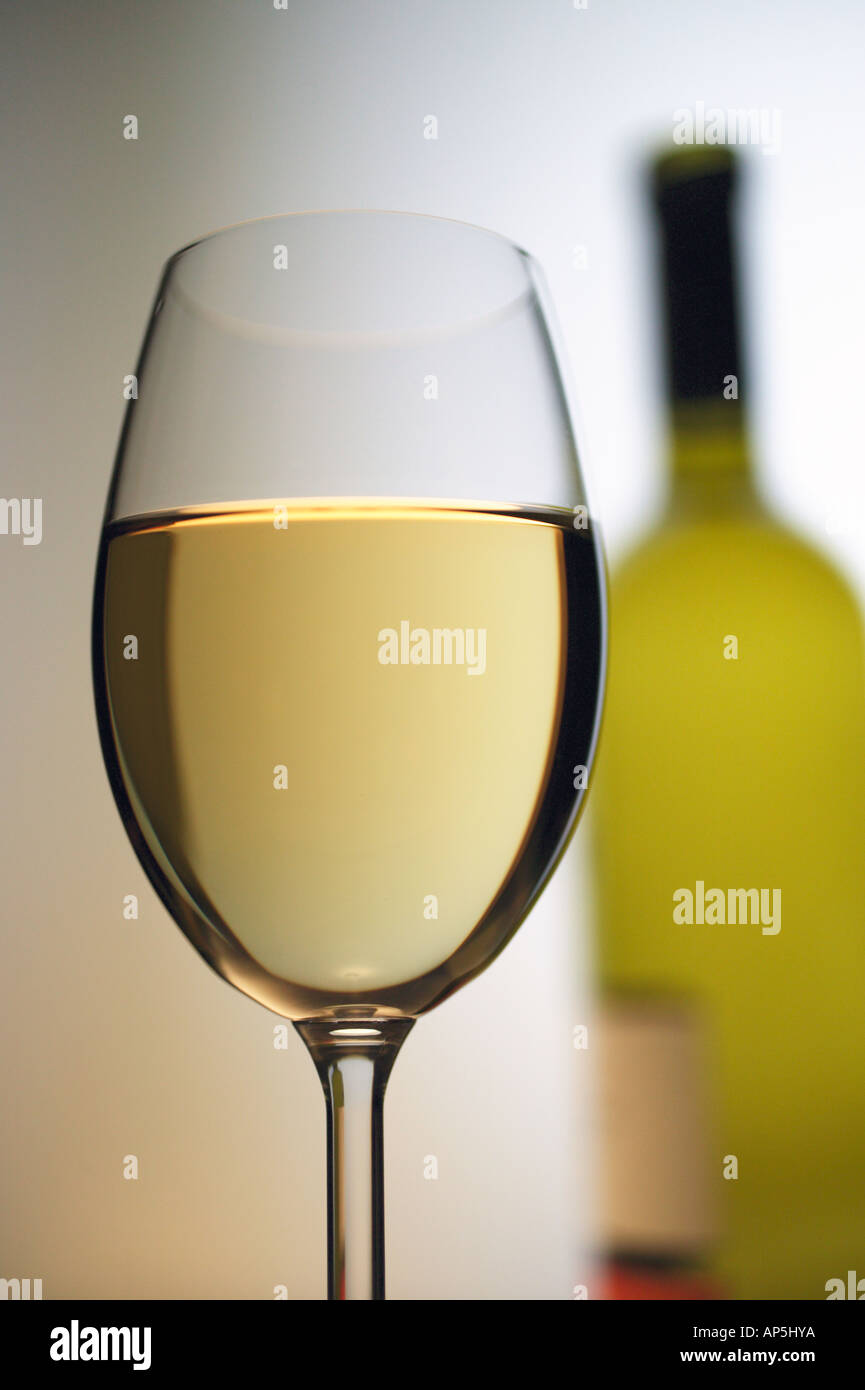 Glass Of White Wine Half Full Bottle, White Background Stock Photo Alamy