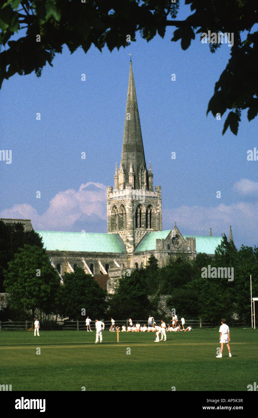 Chichester Cathedral phtographed from Cathedral Fields where pupils of the Prebendal School are playing cricket Stock Photo