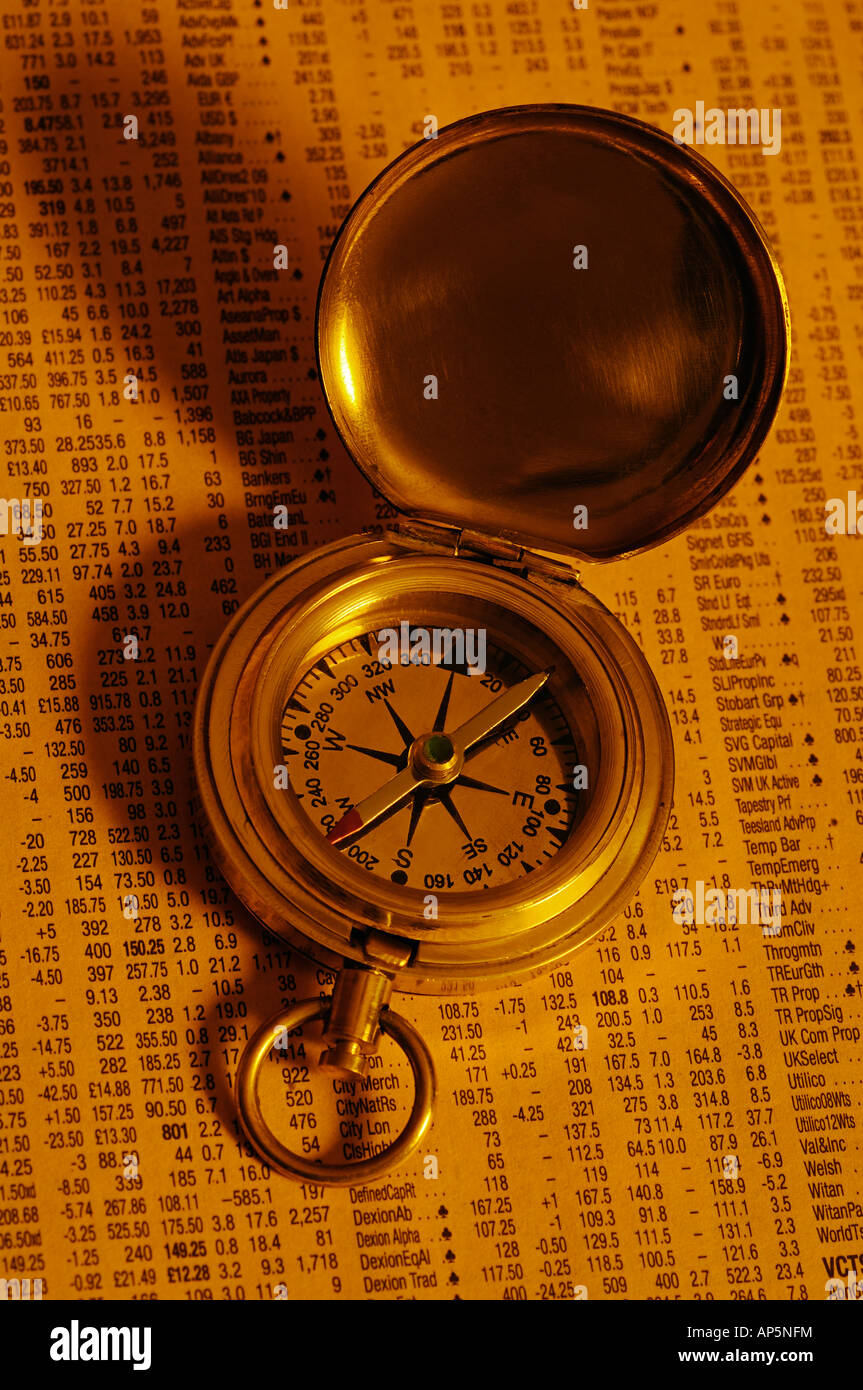 Compass on a Page of a Financial Newspaper Showing Stocks and Share Prices Stock Photo