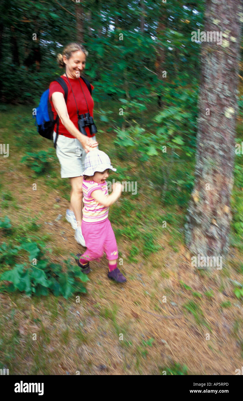 Harwich, MA A woman and her daughter explore a trail in the oak-pine forest near the Monomoy River in Harwich on Cape Cod. Stock Photo