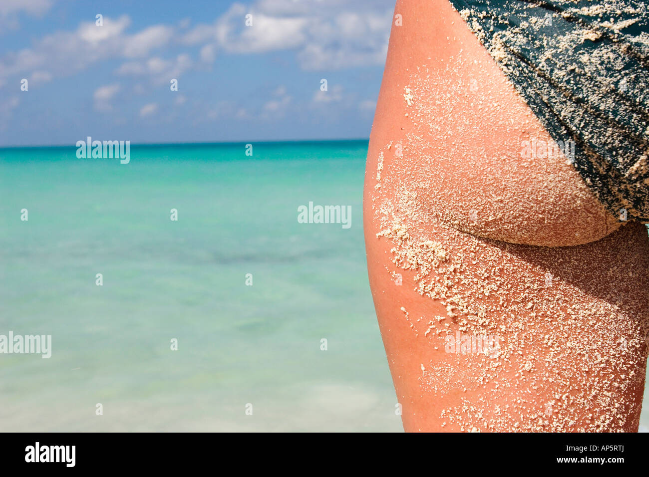 Fotografia do Stock: Sexy young woman with a big booty in the sand on the  beach photo