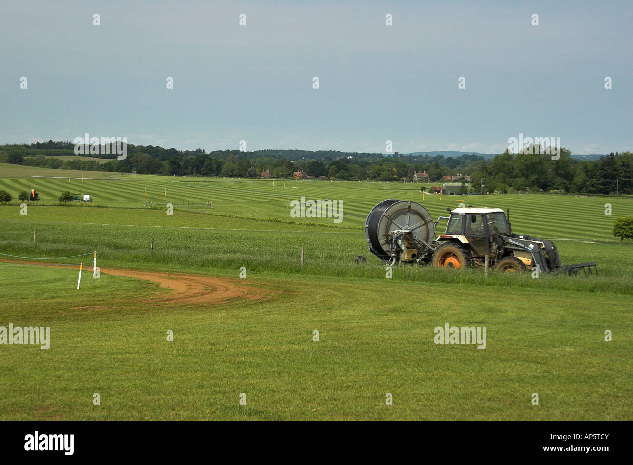 Polo pitches and tractor - Cowdray Park near Midhurst, West Sussex. Stock Photo