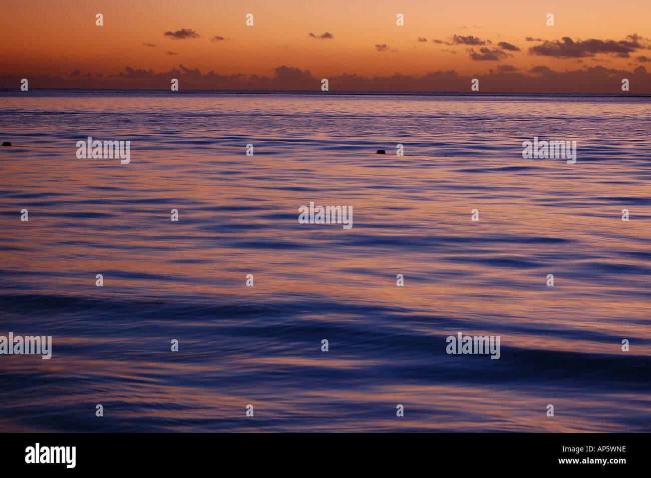 Glow of the sunset reflected in the sea. Stock Photo