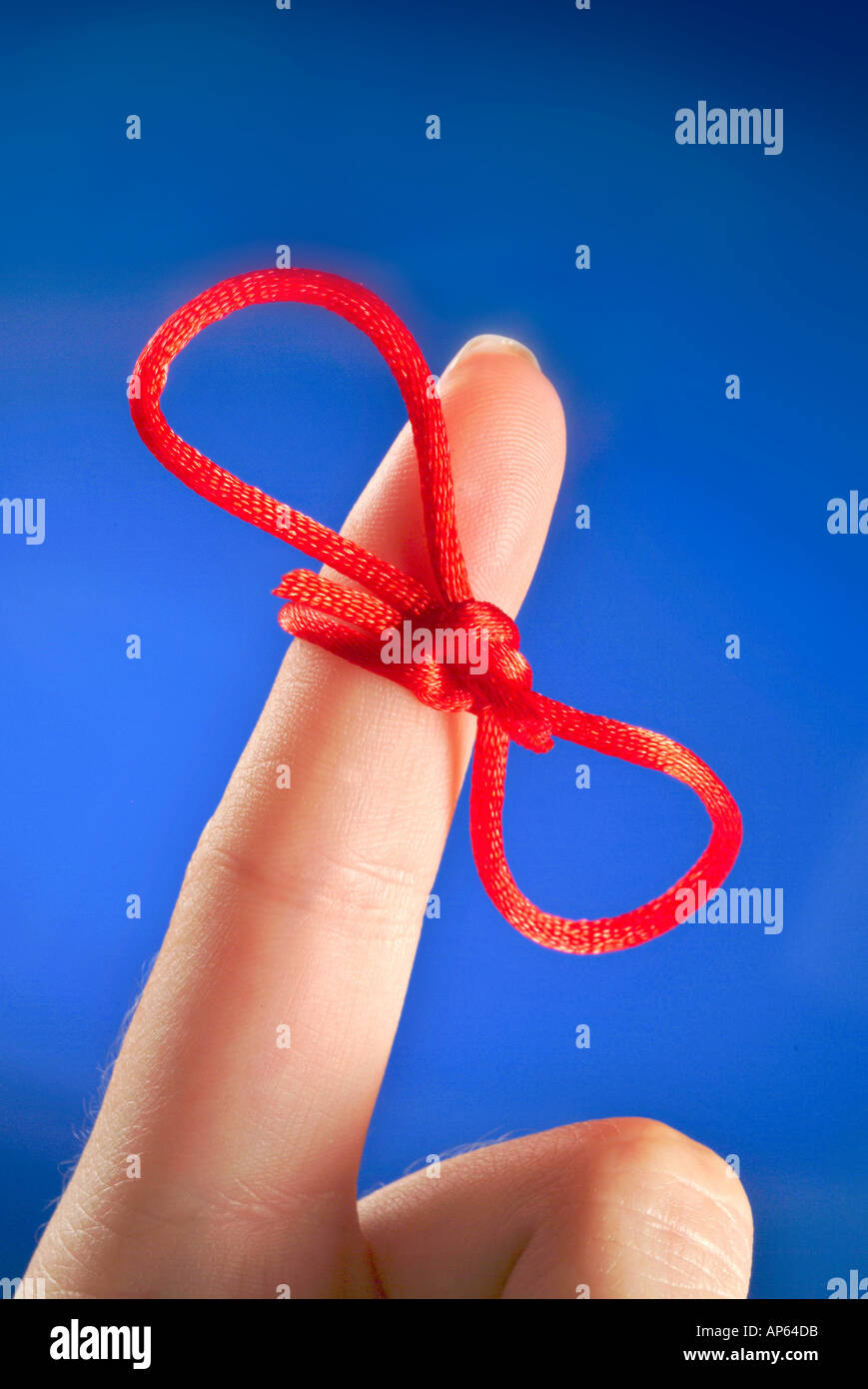 PIECE OF RED STRING TIED AROUND WOMANS INDEX FINGER Stock Photo Alamy