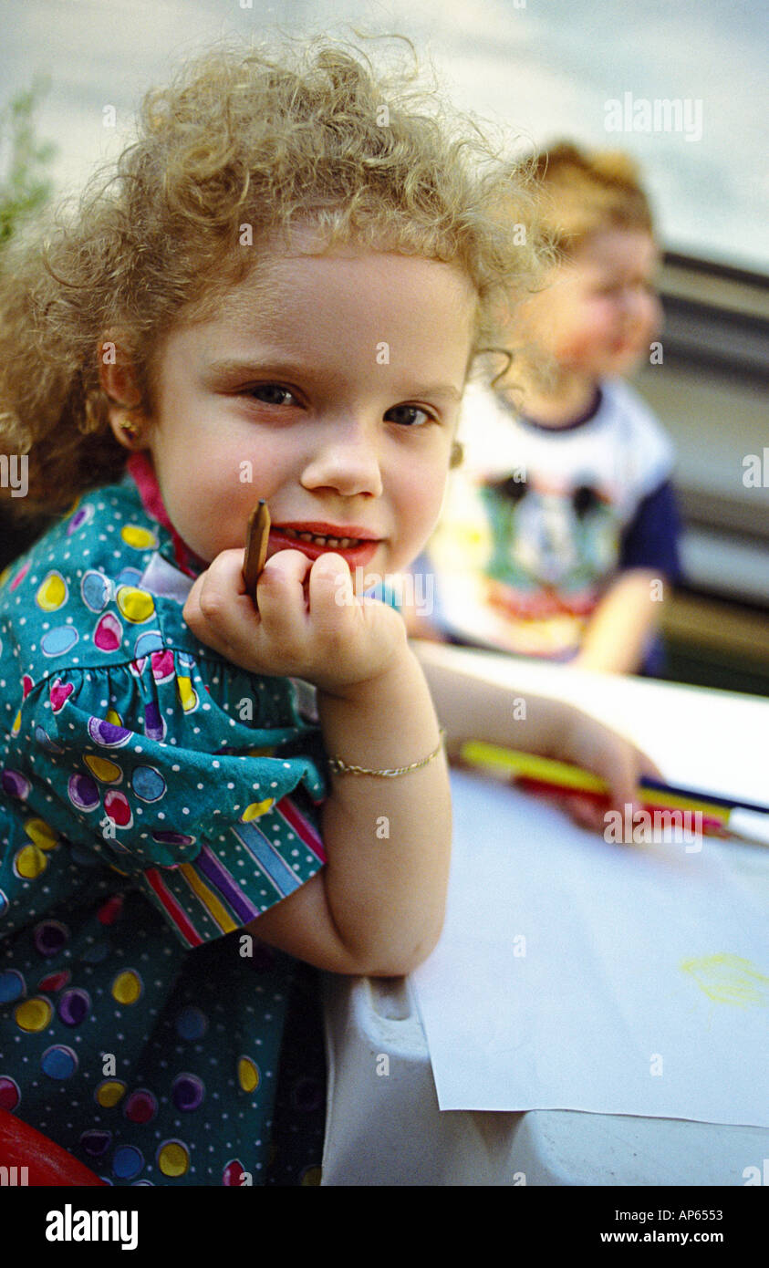 Little girl drawing with coulor pencils Stock Photo - Alamy