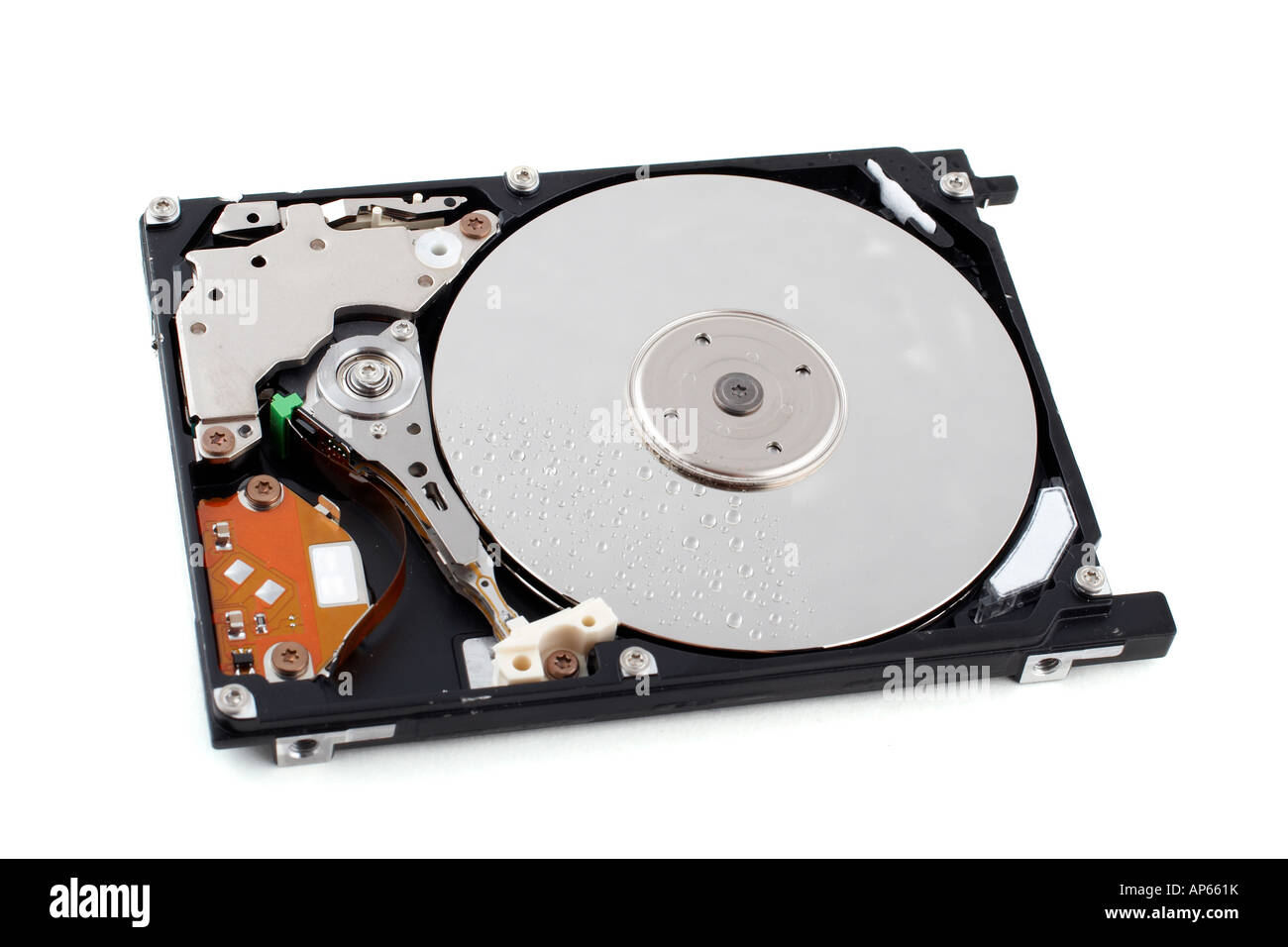Opened hard disk drive with water drops and shadow over a white