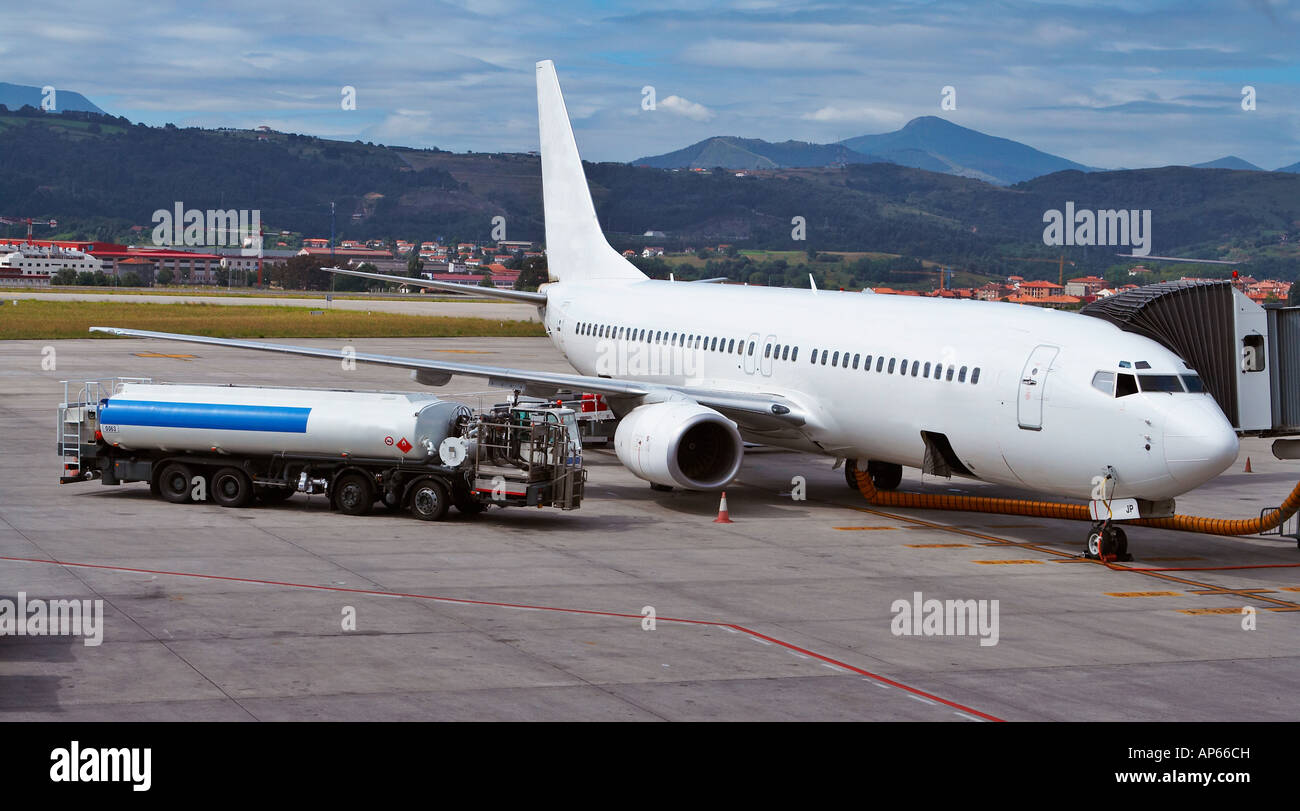 Truck refueling an airplane on the airport Stock Photo - Alamy