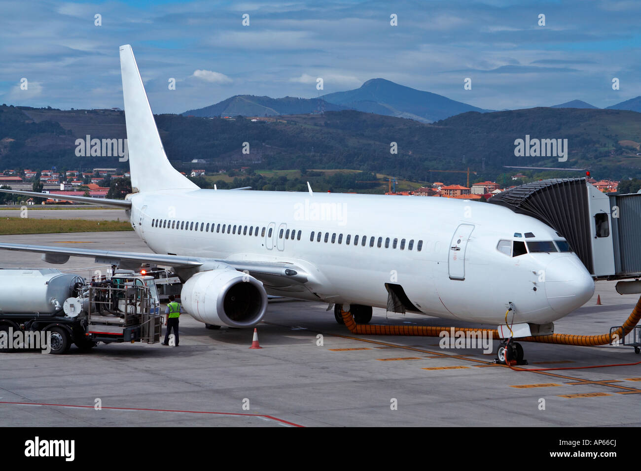 Truck refueling an airplane on the airport Stock Photo - Alamy