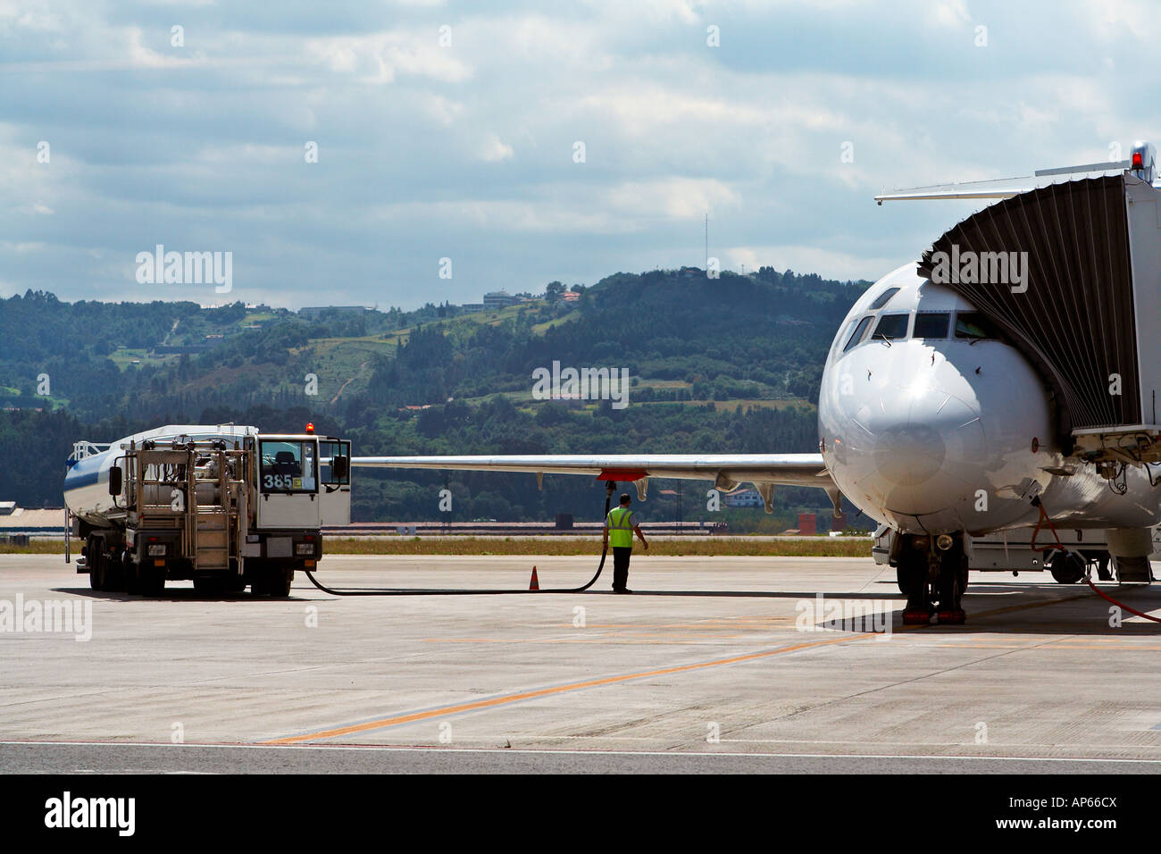 Truck refueling an airplane on the airport Stock Photo - Alamy
