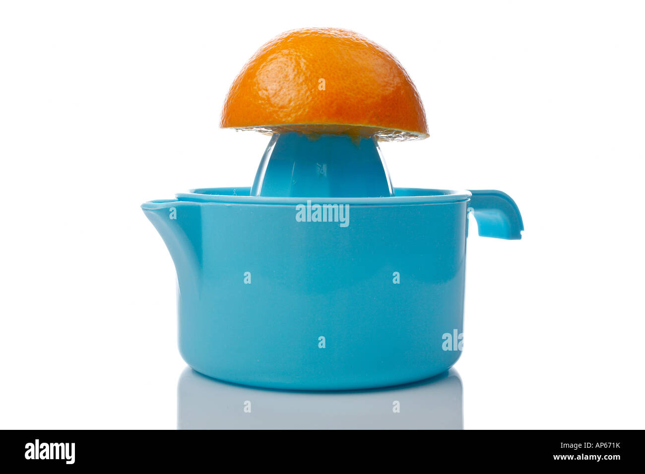 Squeezer and half orange reflected on white background Stock Photo