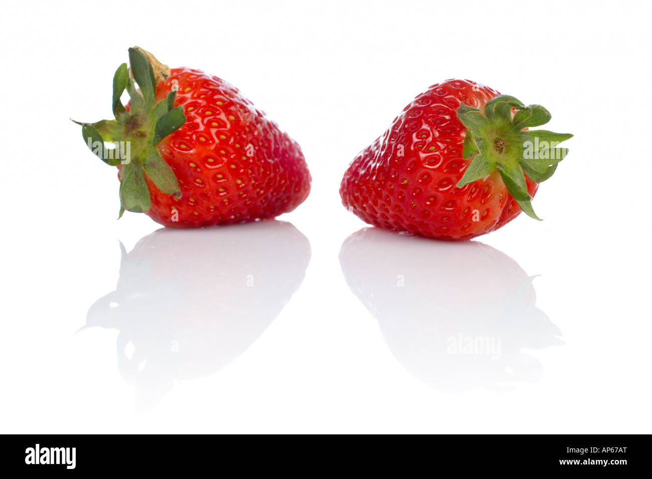 Two fresh and tasty strawberries reflected on white background Stock ...