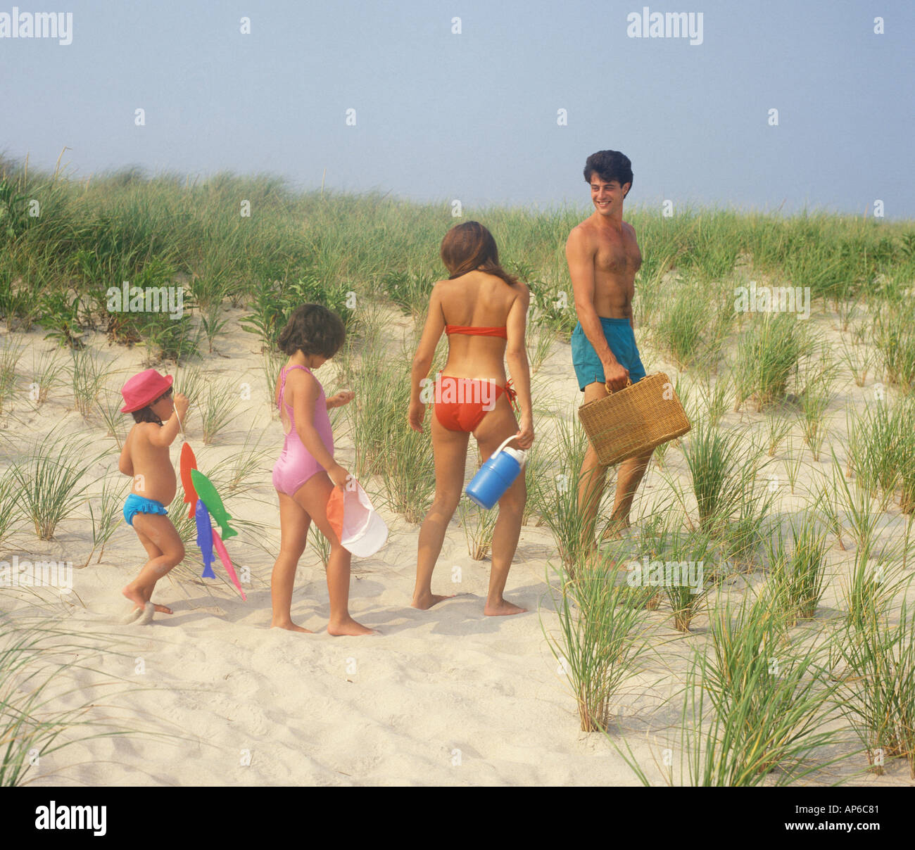 family walking on beach to picnic area Stock Photo