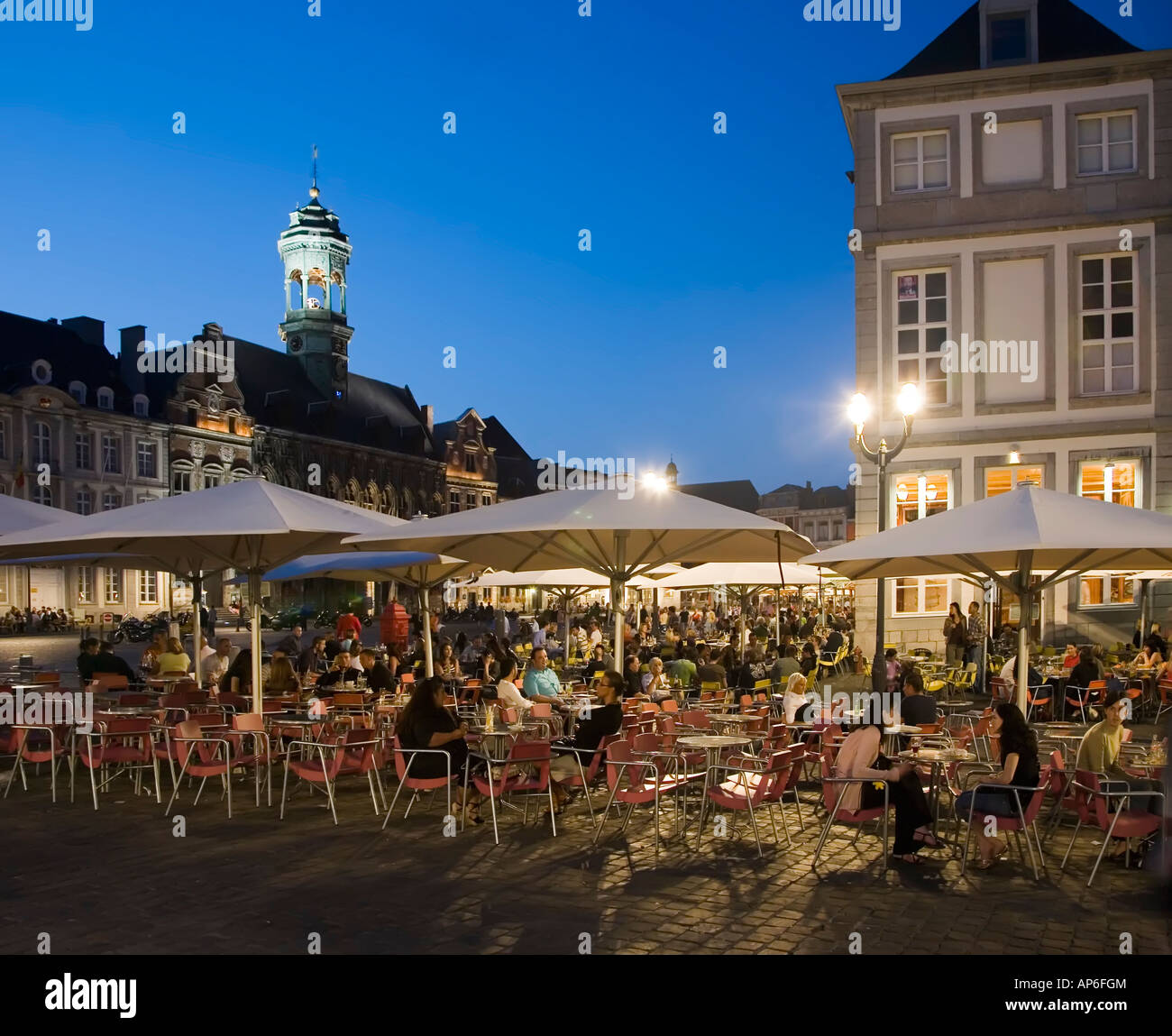 People drinking and eating outdoors at bars and restaurants in street
