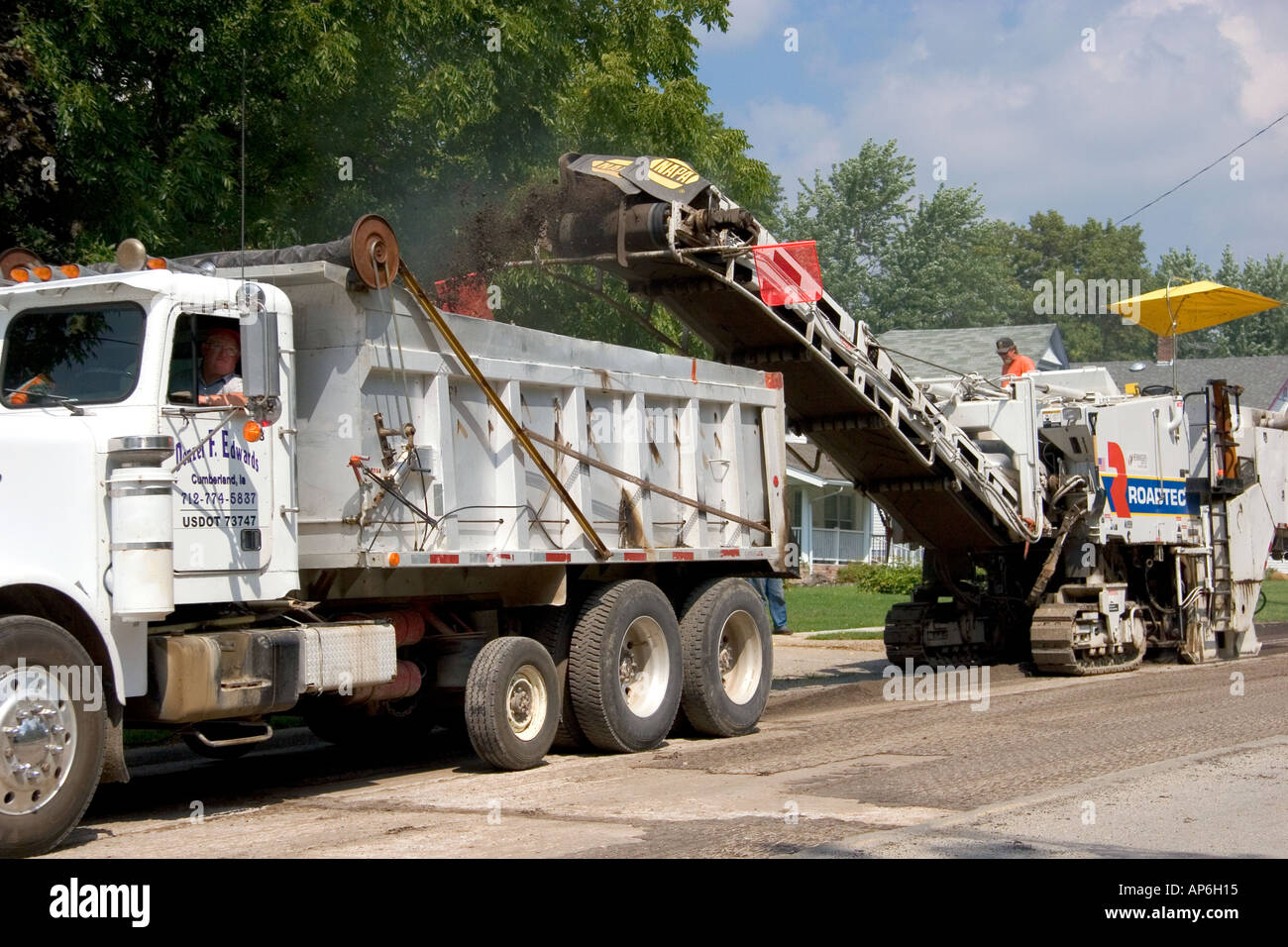 A road construction crew uses machinery to recycle asphalt in Oceola