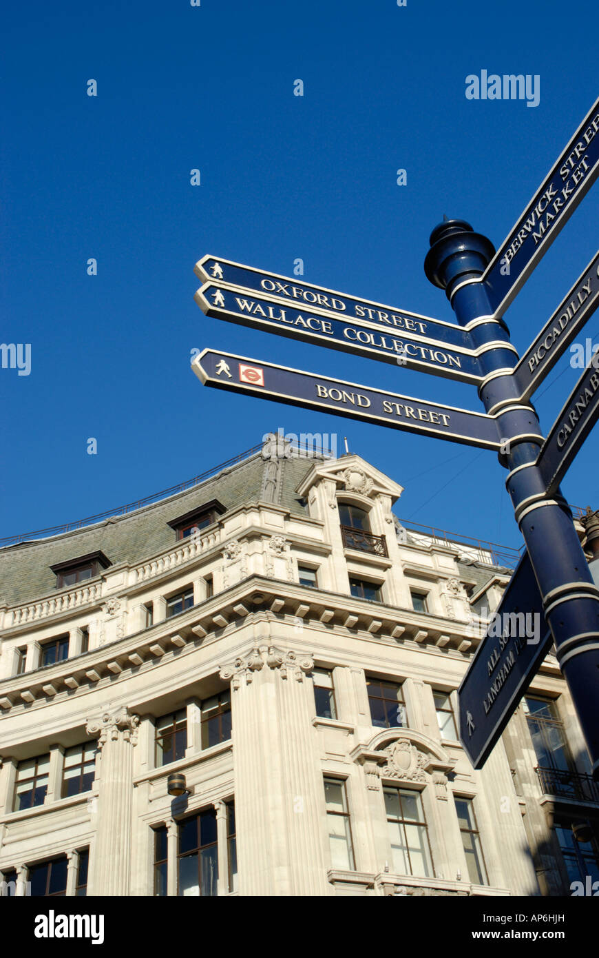 Pedestrian signposts and ornate Victorian Building at Oxford Circus London England 2007 Stock Photo
