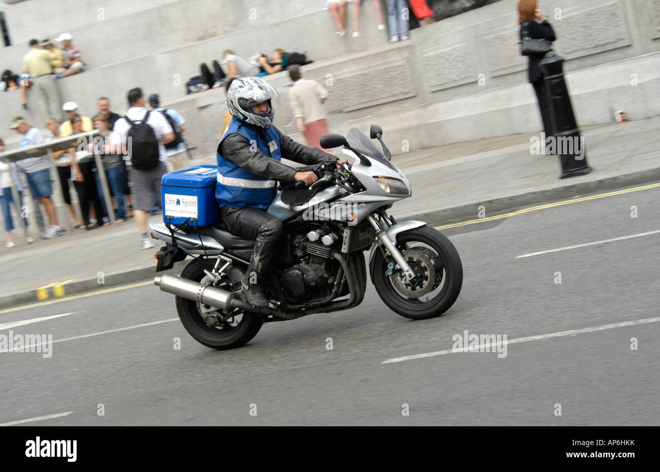 Motorcycle courier traveling in London traffic, England Stock Photo Alamy