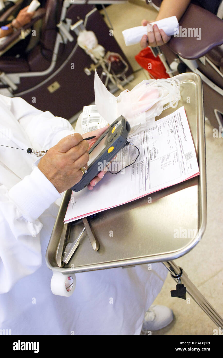 Close up of a Nurse checking a patients data into a PDA machine prior