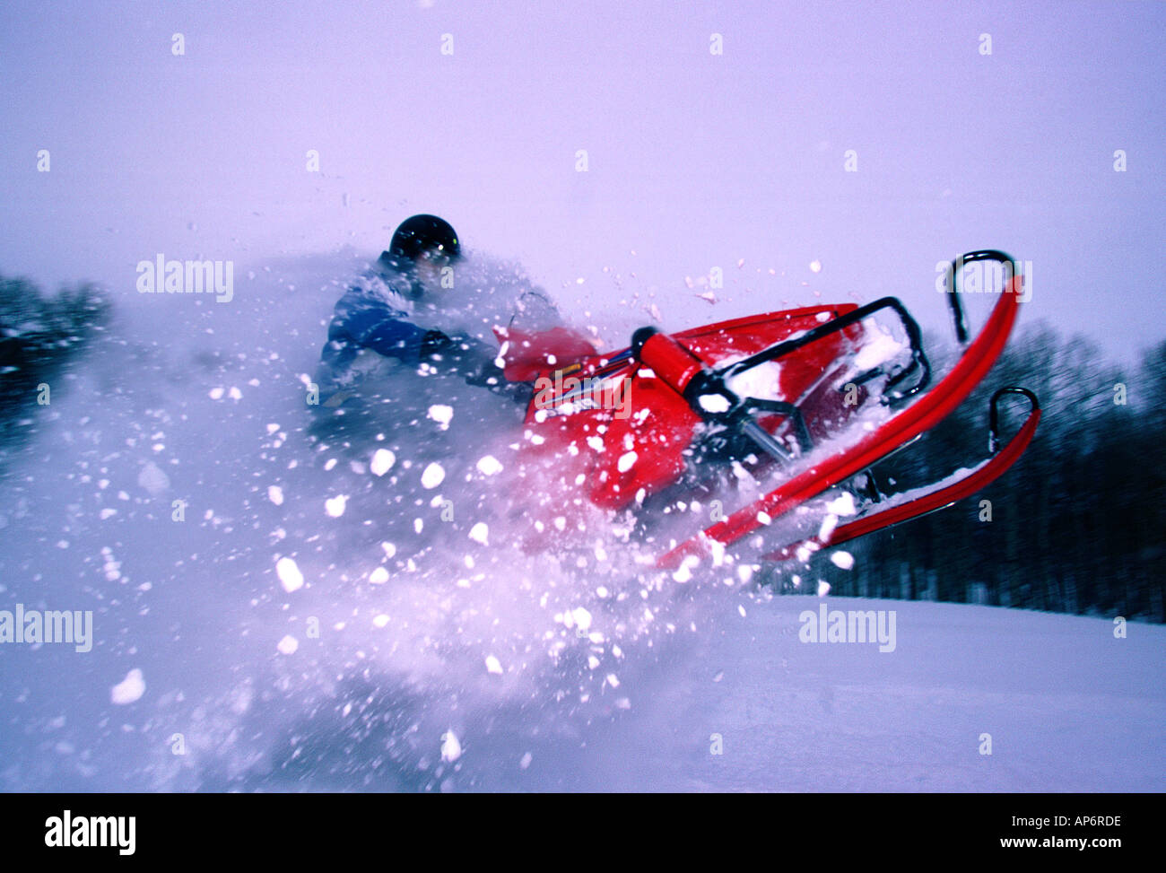 Snowmobile launching through powder snow Stock Photo