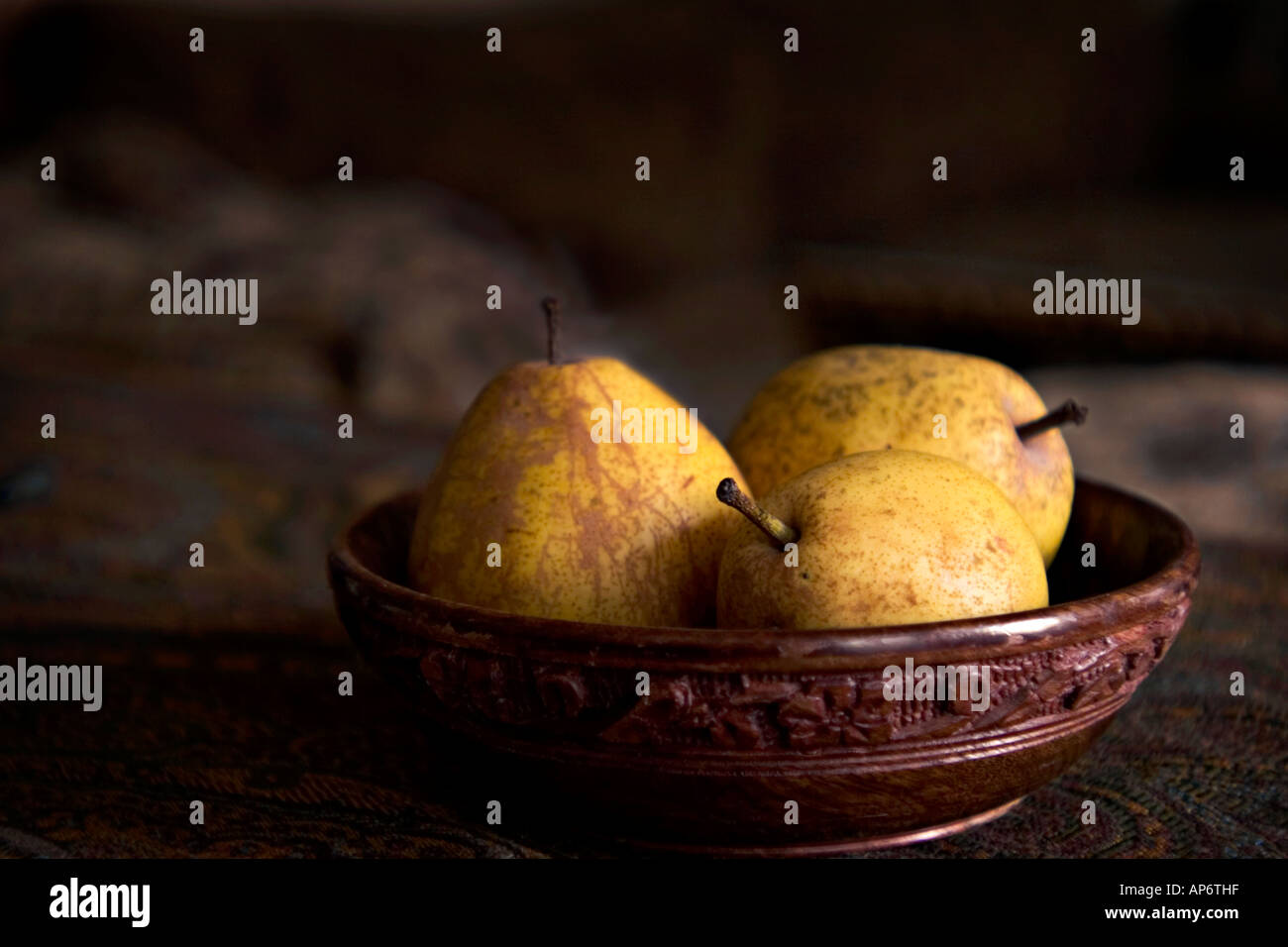 three pears in a wooden bowl Stock Photo