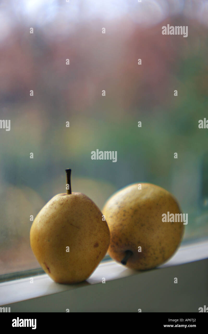 two pears on a window sill with a colorful background Stock Photo
