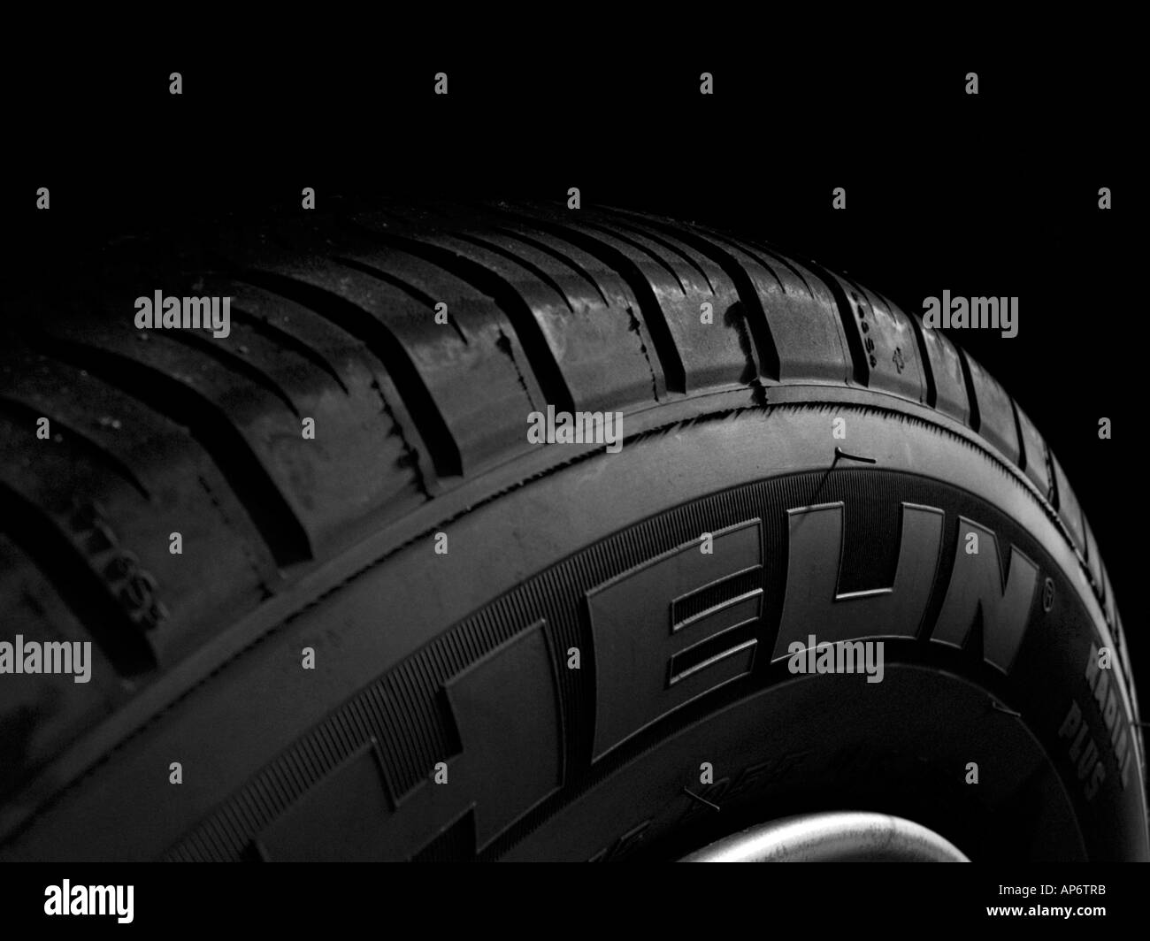 closeup of a radial tire on dark background. Stock Photo