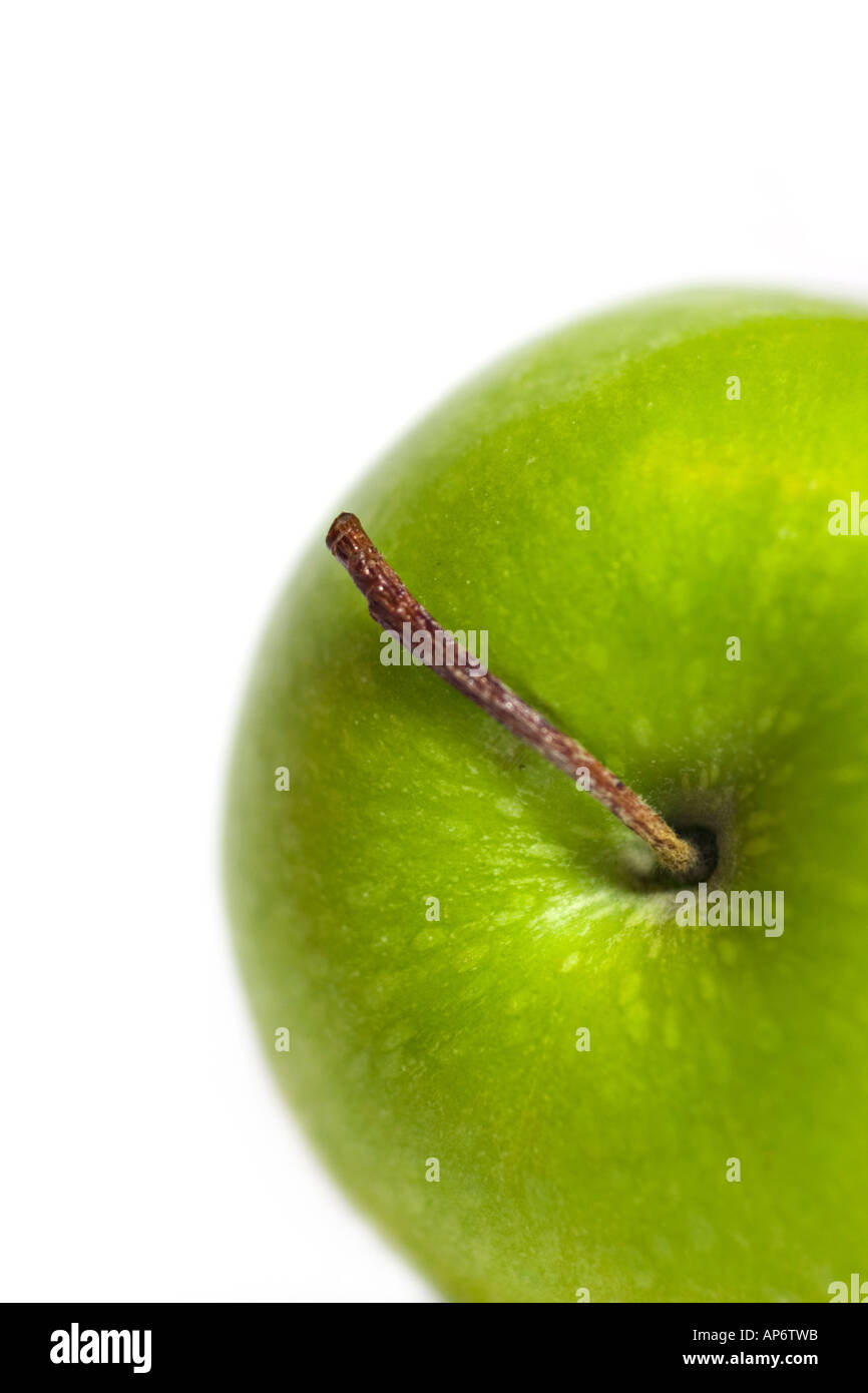 closeup of green apple with a long stem on a white background Stock Photo