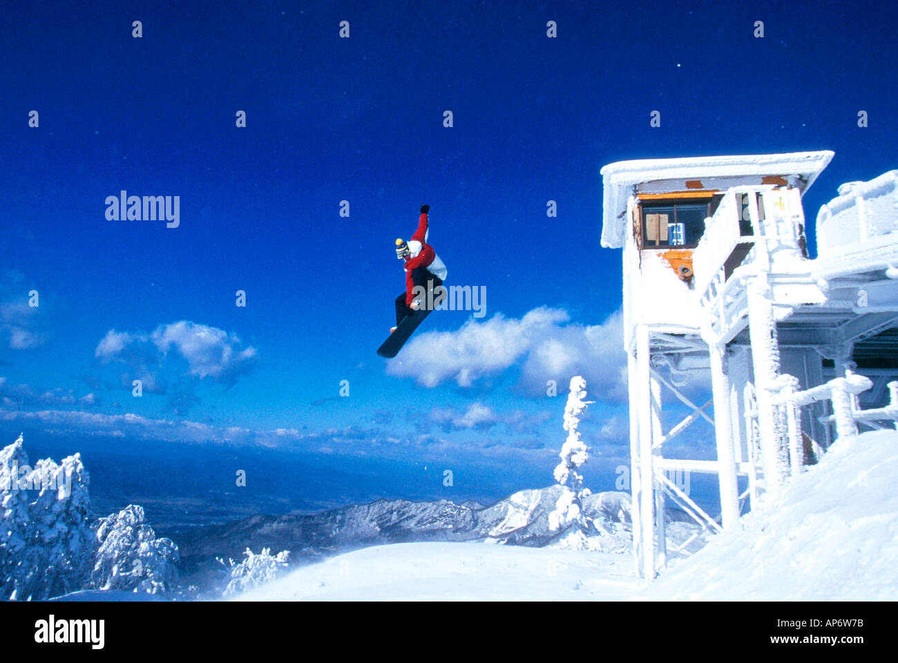 Mid-air snowboard action, jumping from chairlift, Stuart Brass, Japan Stock Photo