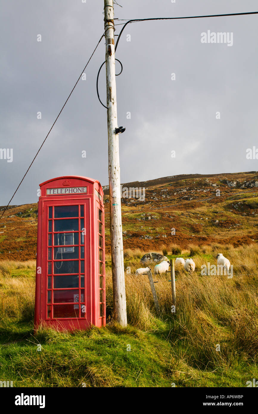 Vintage British Telecom GPO red telephone box in Highlands of Scotland with sheep in background Stock Photo