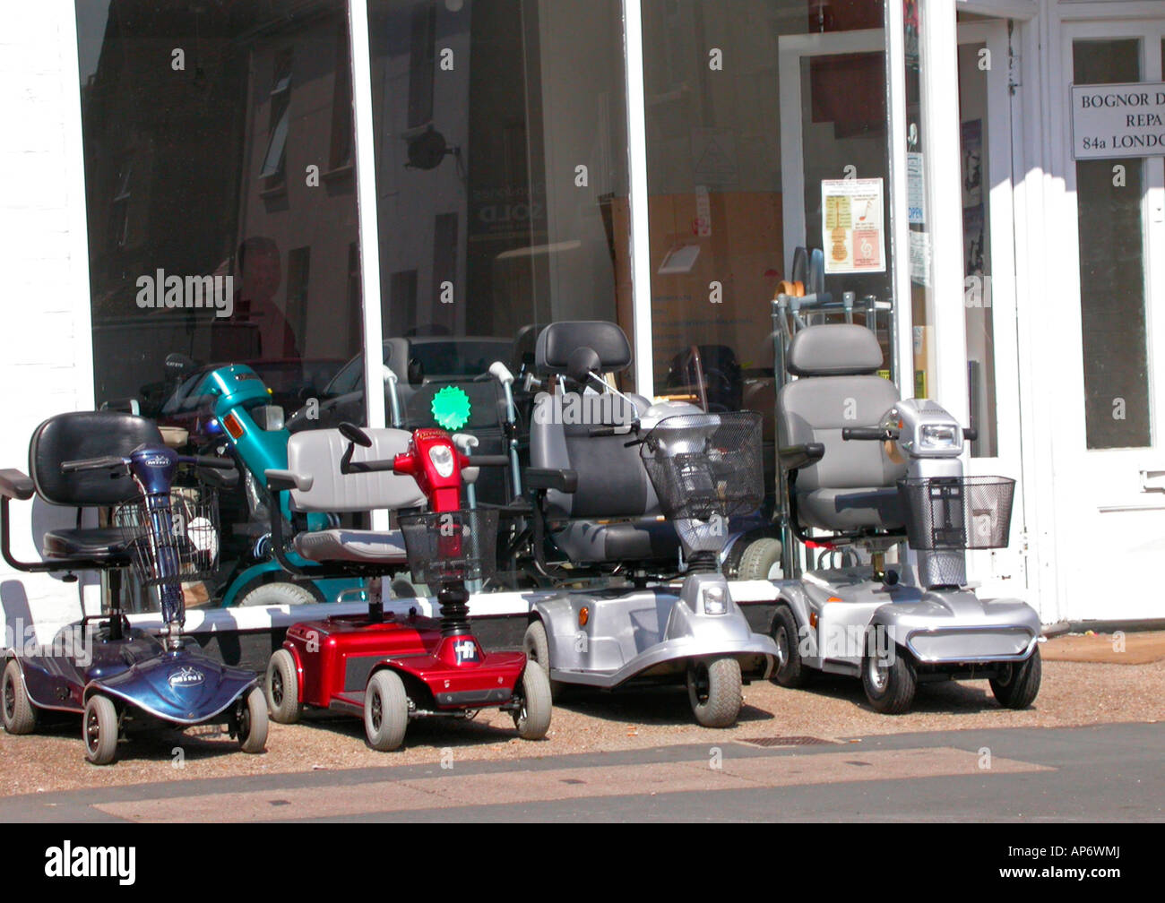 electronic motorised scooters for sale hire and repair in a specialised shop Bognor Regis West Sussex Stock Photo