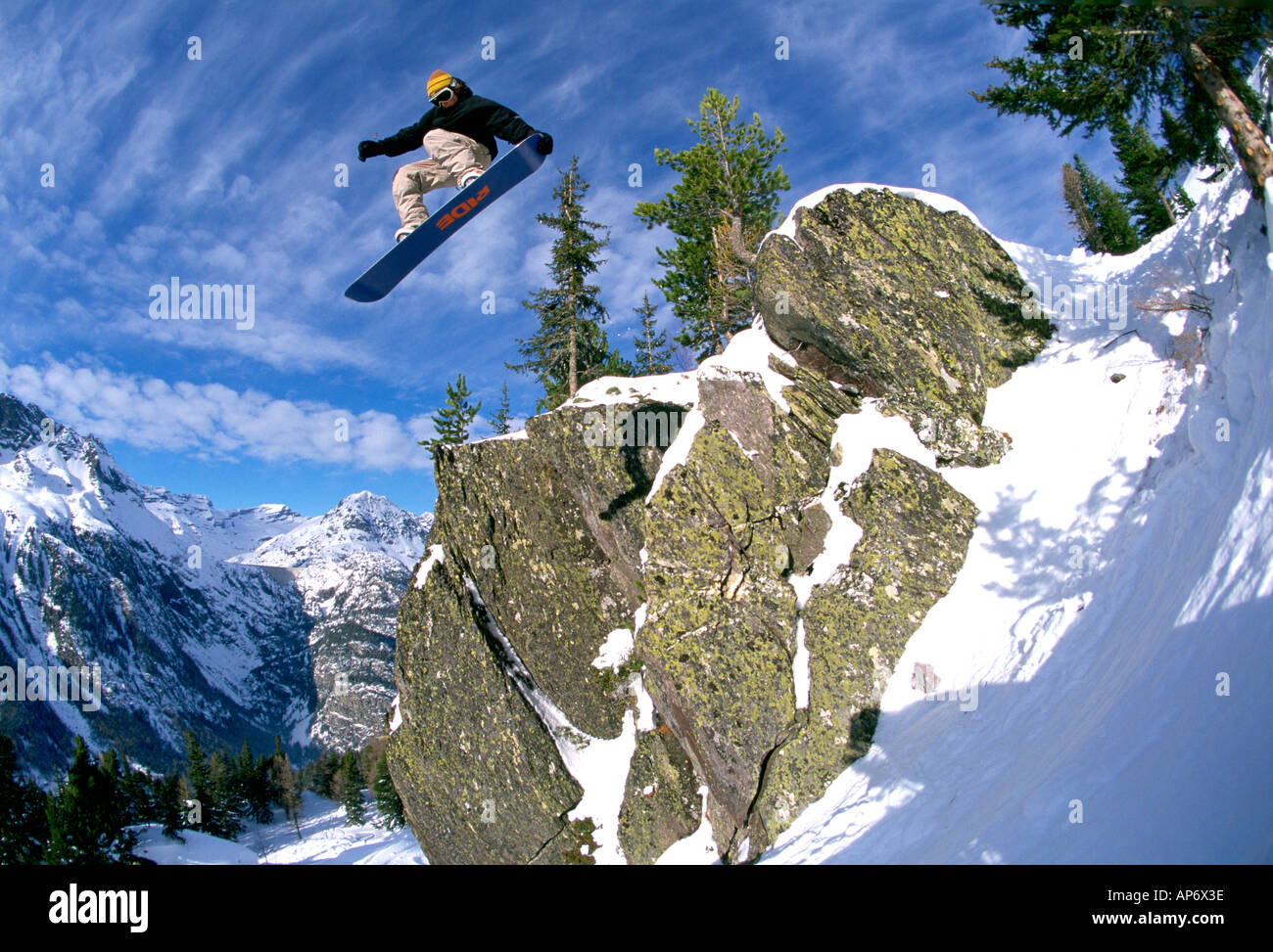 Mid air snow-boarding stunt and rock, Jonny Barr, Chamonix, France Stock Photo