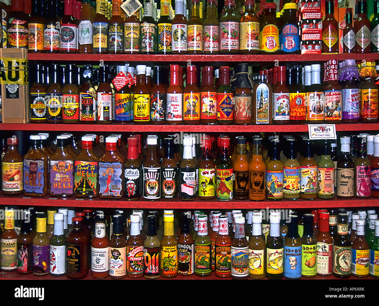 A colorful display of bottled hot sauce varieties on store shelves New