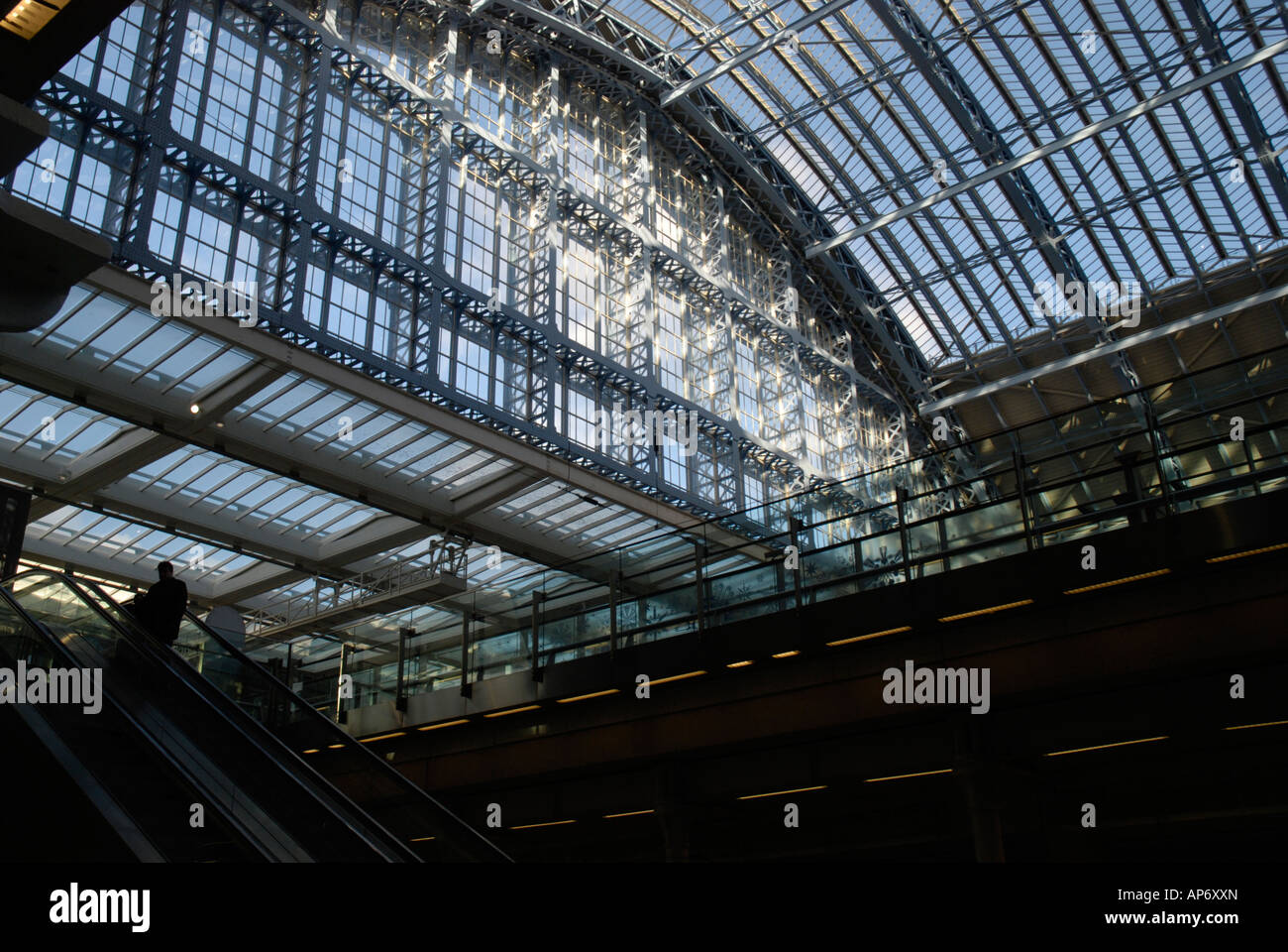 Interior of St Pancras International railway station showing roof and escalator Stock Photo