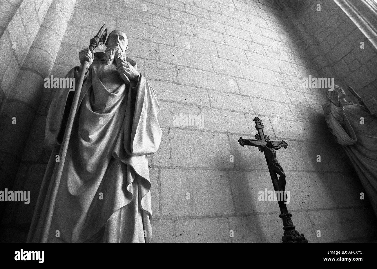 statue of shepherd with staff or crook in church in monochrome wth cricifix Stock Photo