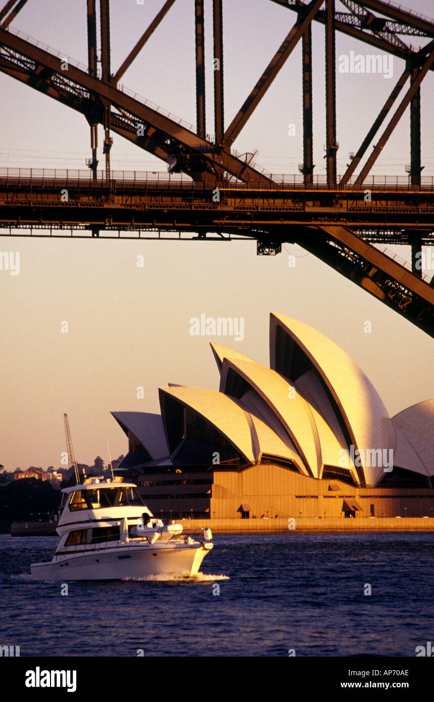 Sydney opera house under the Famous Sydney Harbour Bridge at dusk I luxurious speedboat cursing under the bridge vertical image Stock Photo