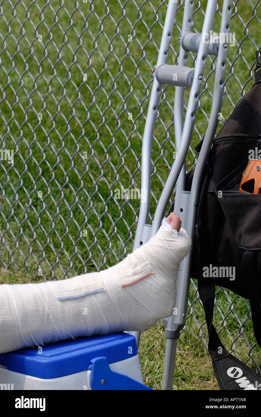 Female softball player sprains ankle from Sports injury due to playing