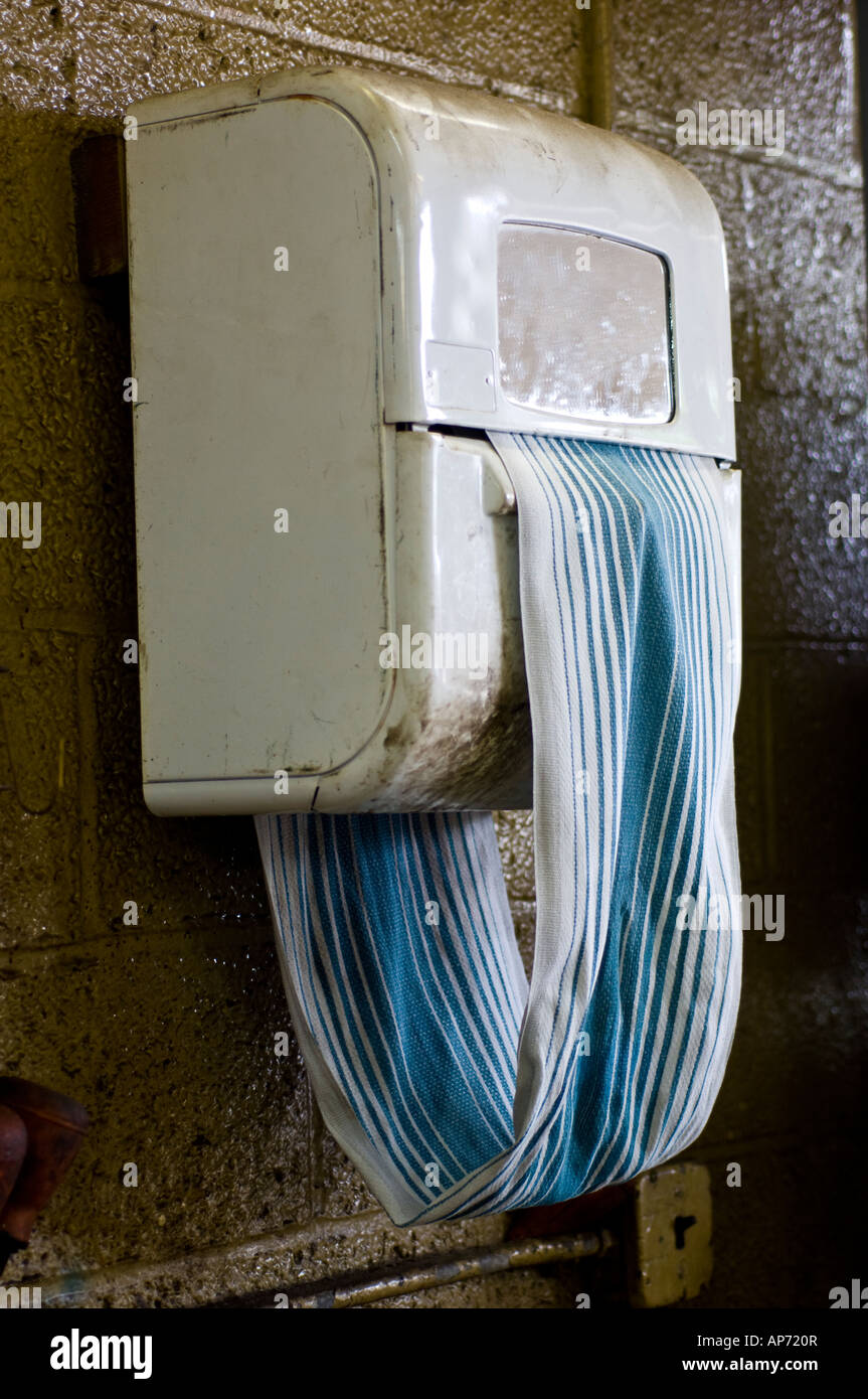 Rolling towel dispenser in automotive repair shop garage Stock Photo