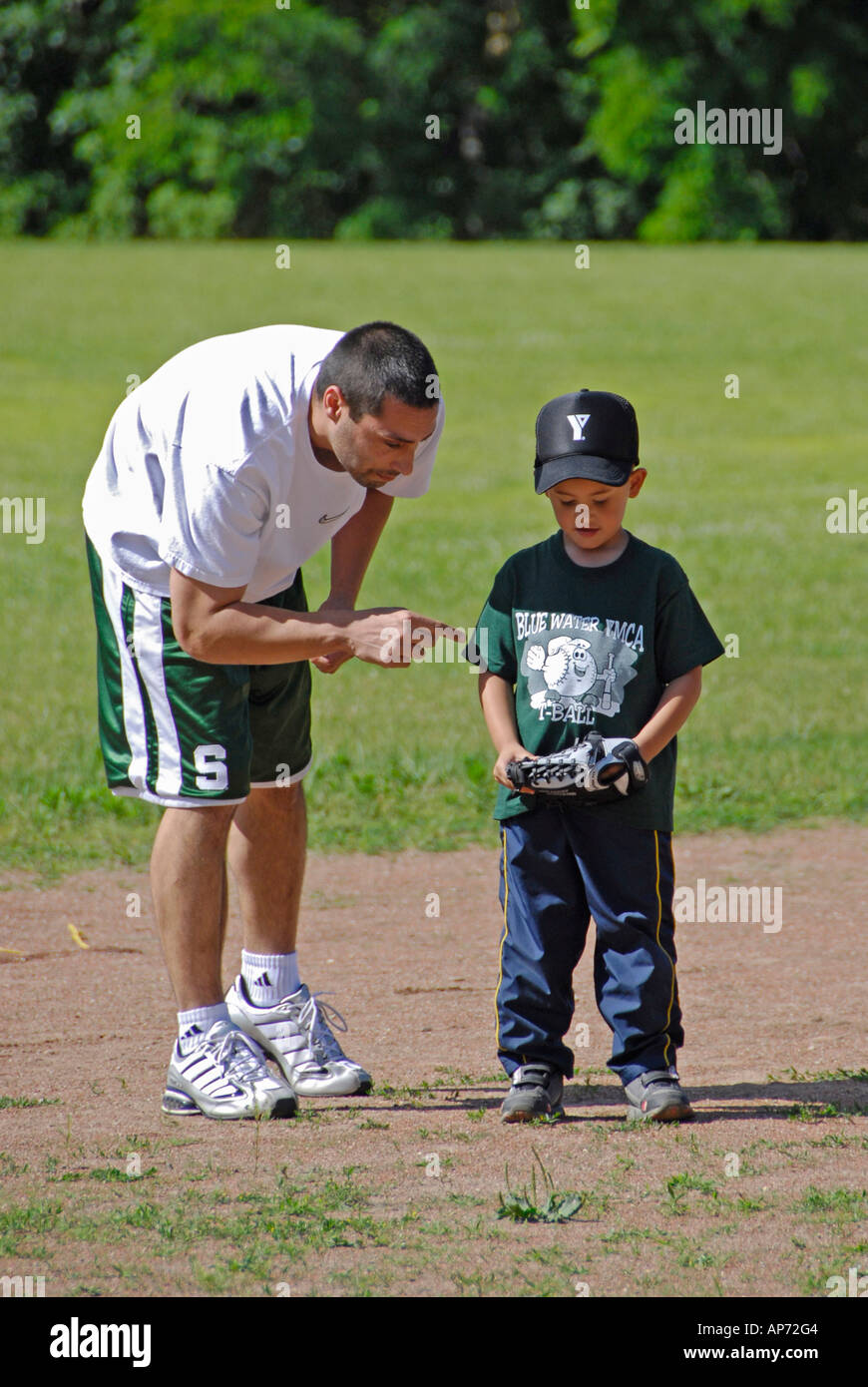 5 to 7 year old Children get their first experience playing baseball from a T Stock Photo