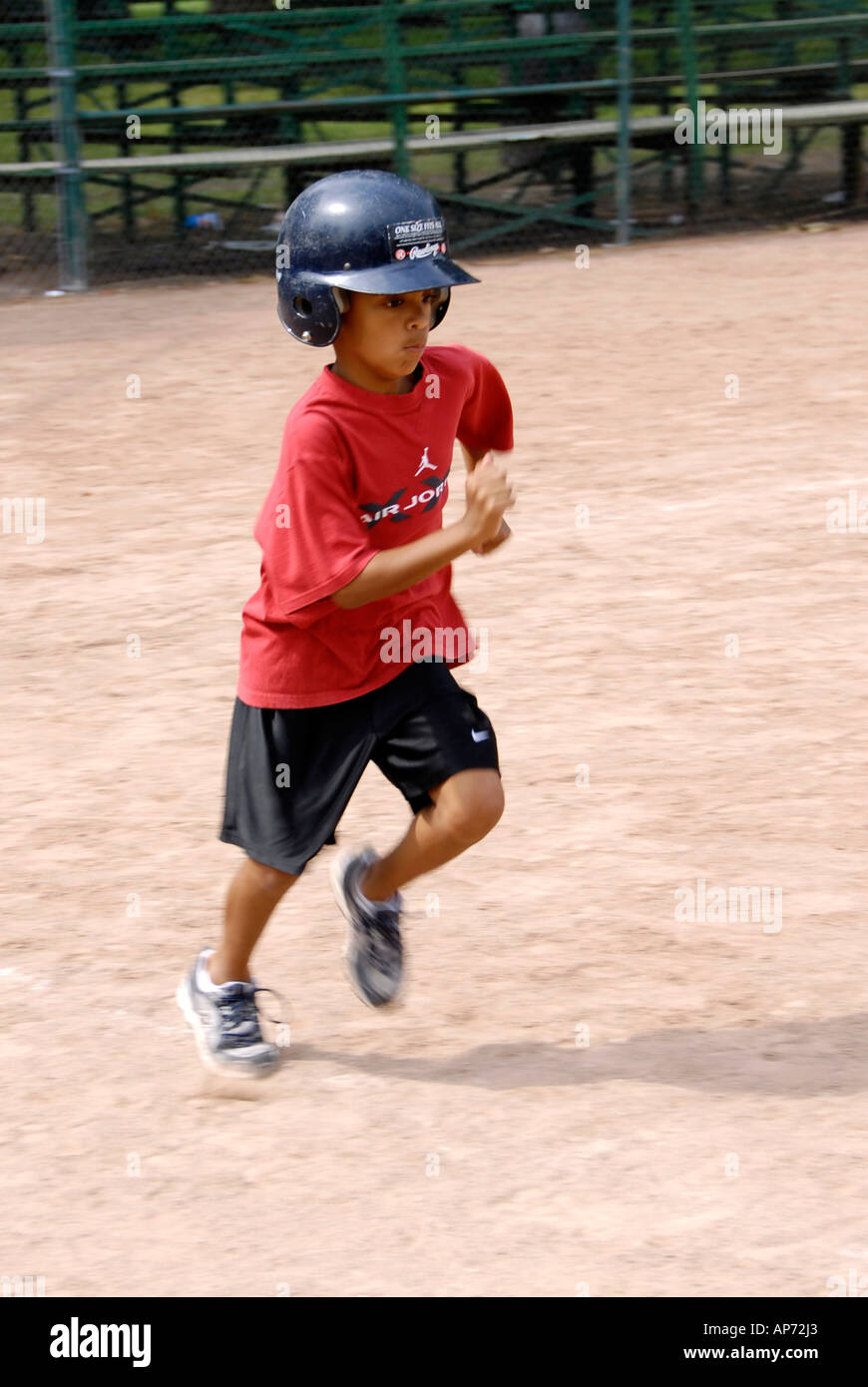 5 to 7 year old Children get their first experience playing baseball from a T Stock Photo