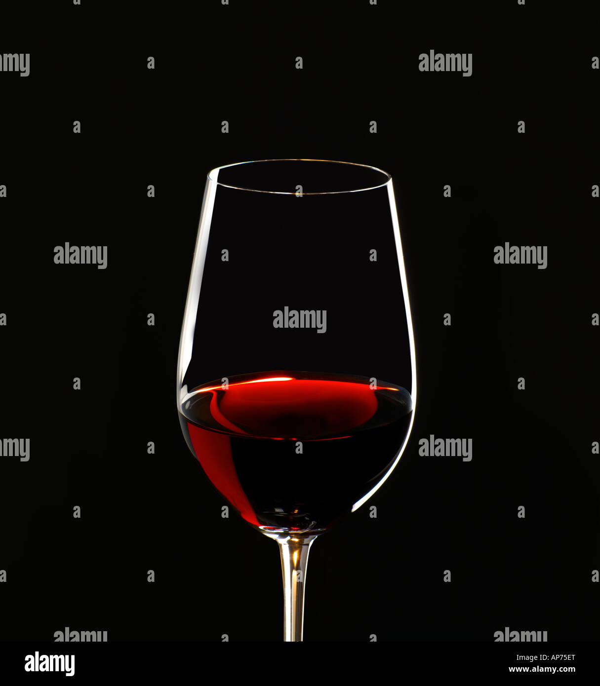 red wine in glass tilted back to show the hues and colours of the