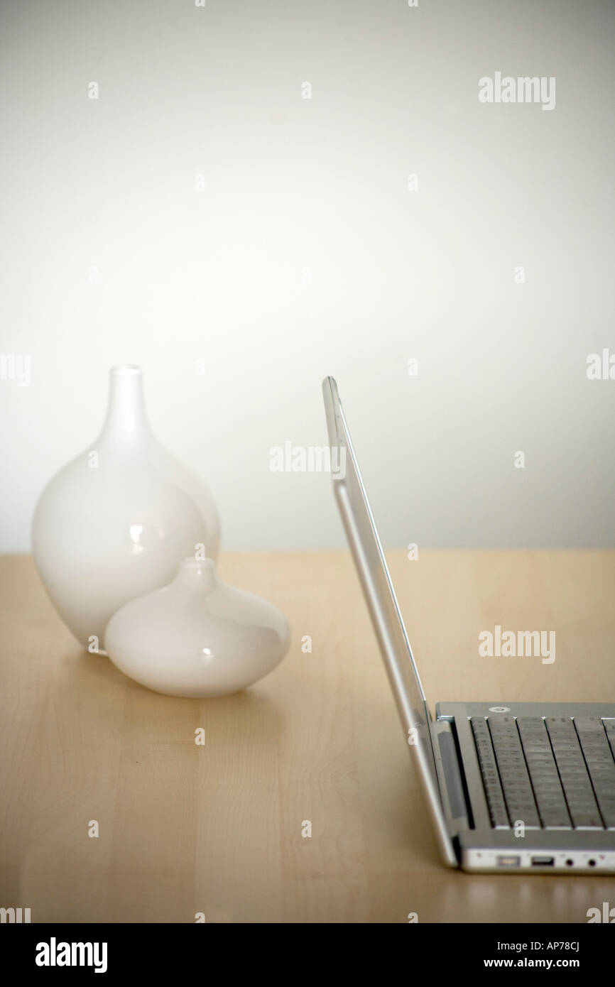laptop computer  on modern desk simple clean vertical room for type home office or office work Stock Photo