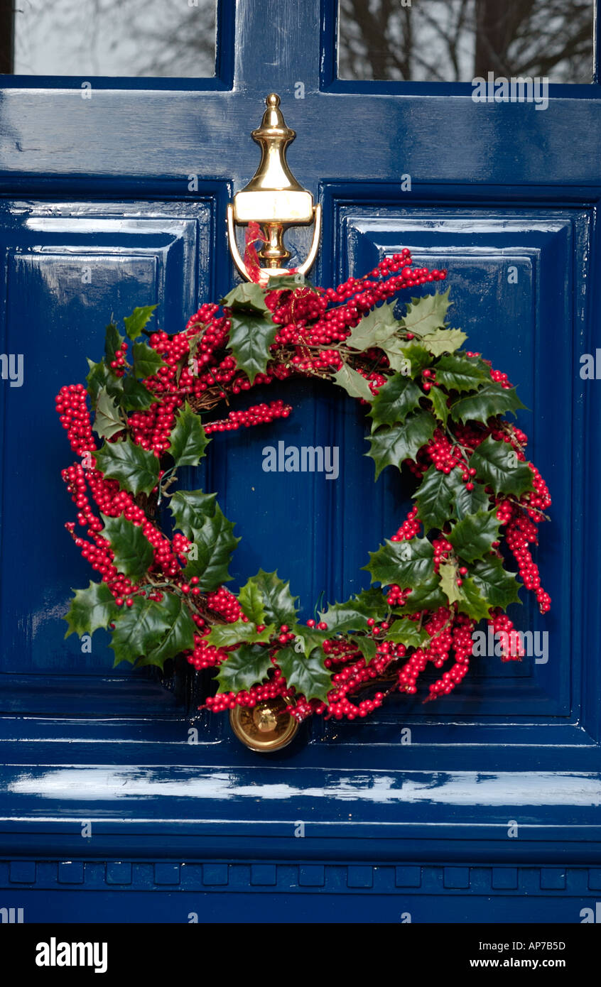 Christmas holly wreath on front door Stock Photo - Alamy