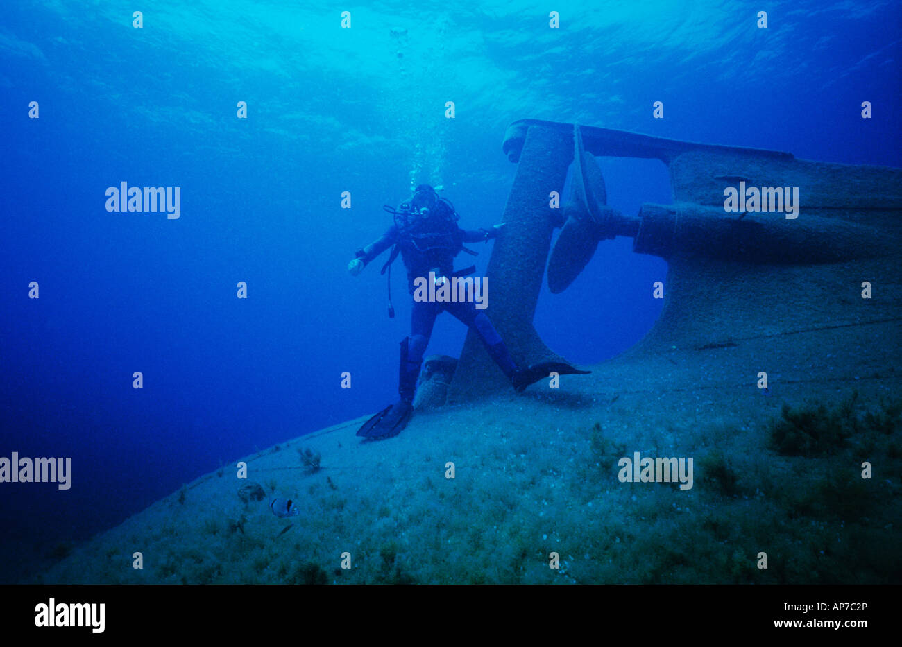 Scuba diver, standing by the propeller of the Achilleas ship wreck, near Paphos Cyprus. Stock Photo