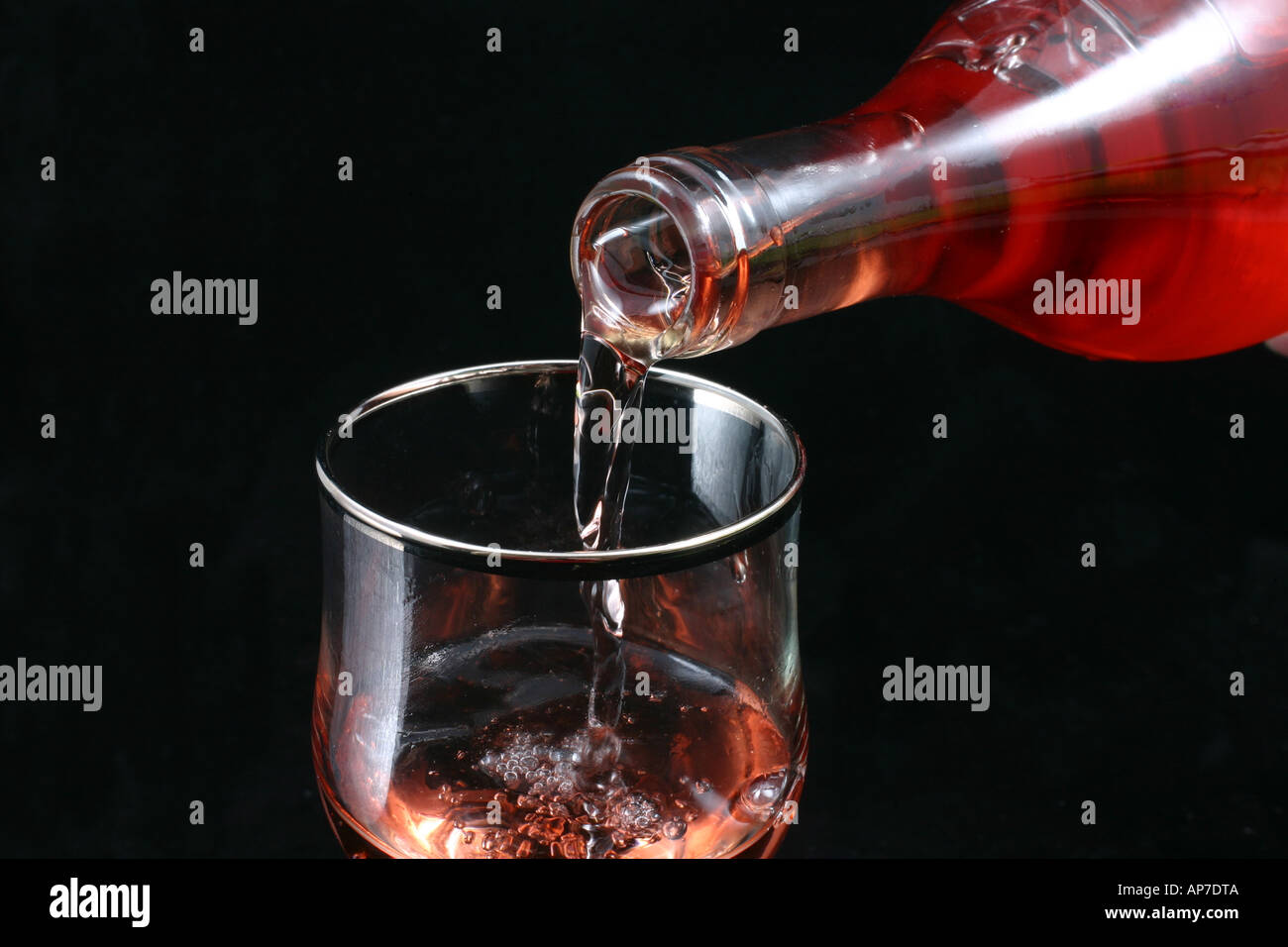 Pouring rose wine into a glass Stock Photo - Alamy