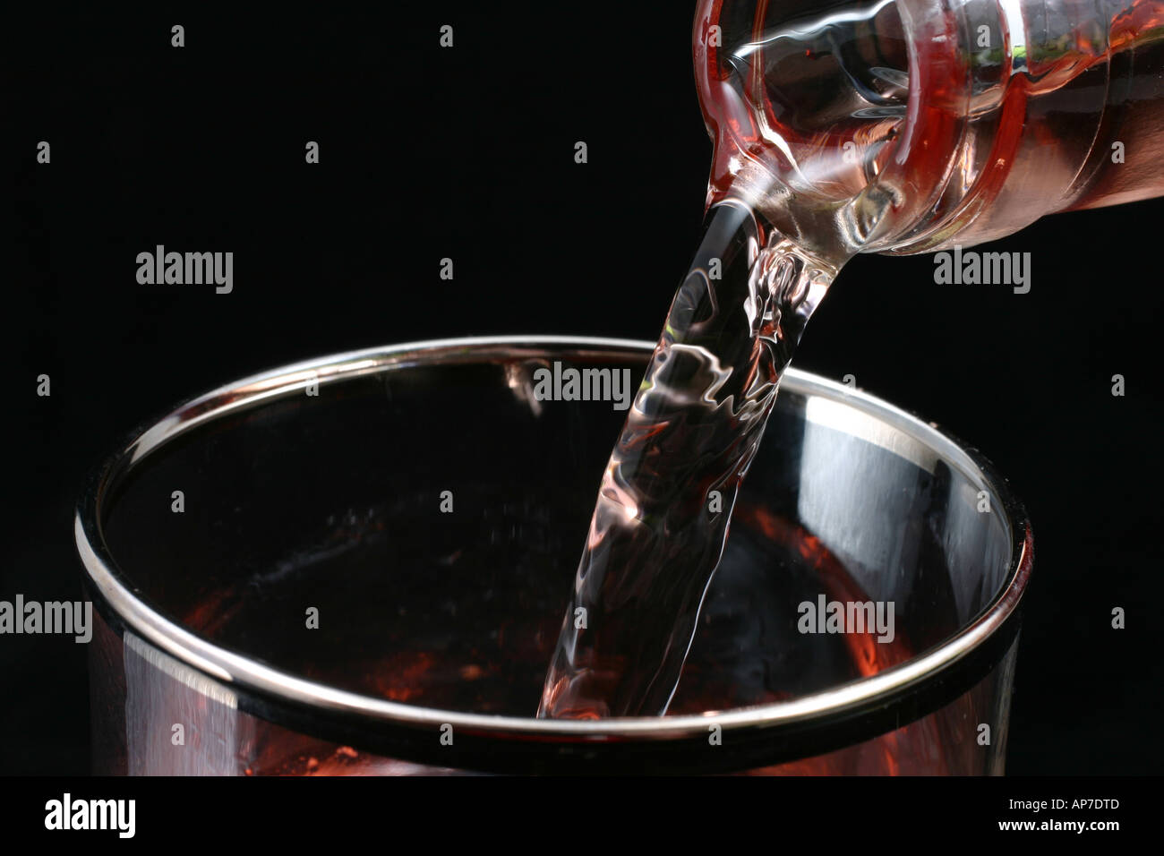 Pouring rose wine into a wine glass Stock Photo - Alamy