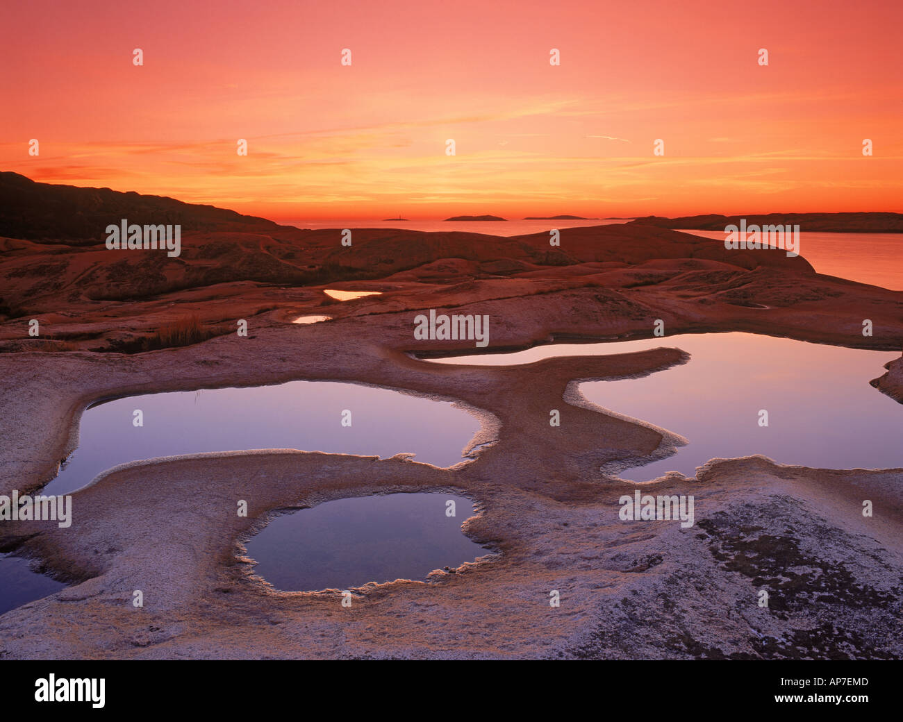 Rock formations and tide pools at Ramsvik in Bohuslän on Sweden's west coast at sunset Stock Photo
