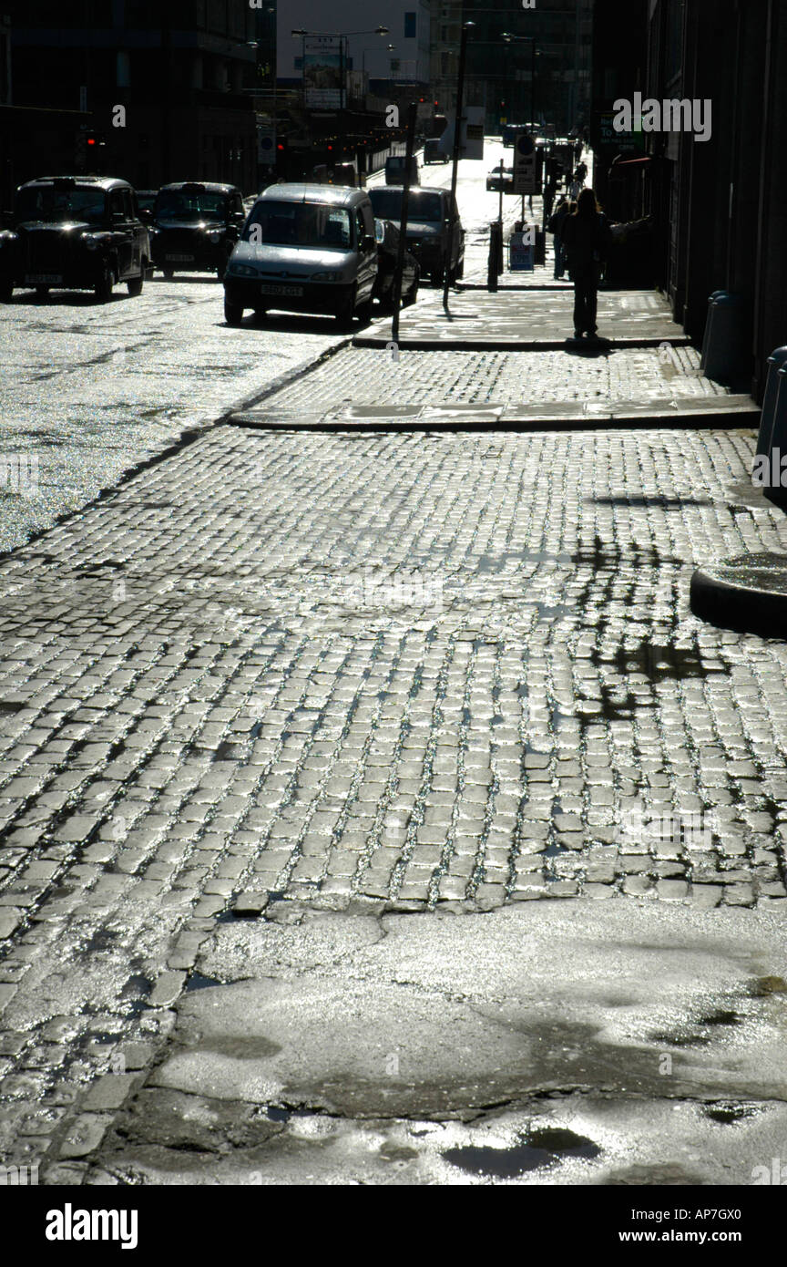 Cobbled pavement after rain Charterhouse Street Smithfield London UK Stock Photo