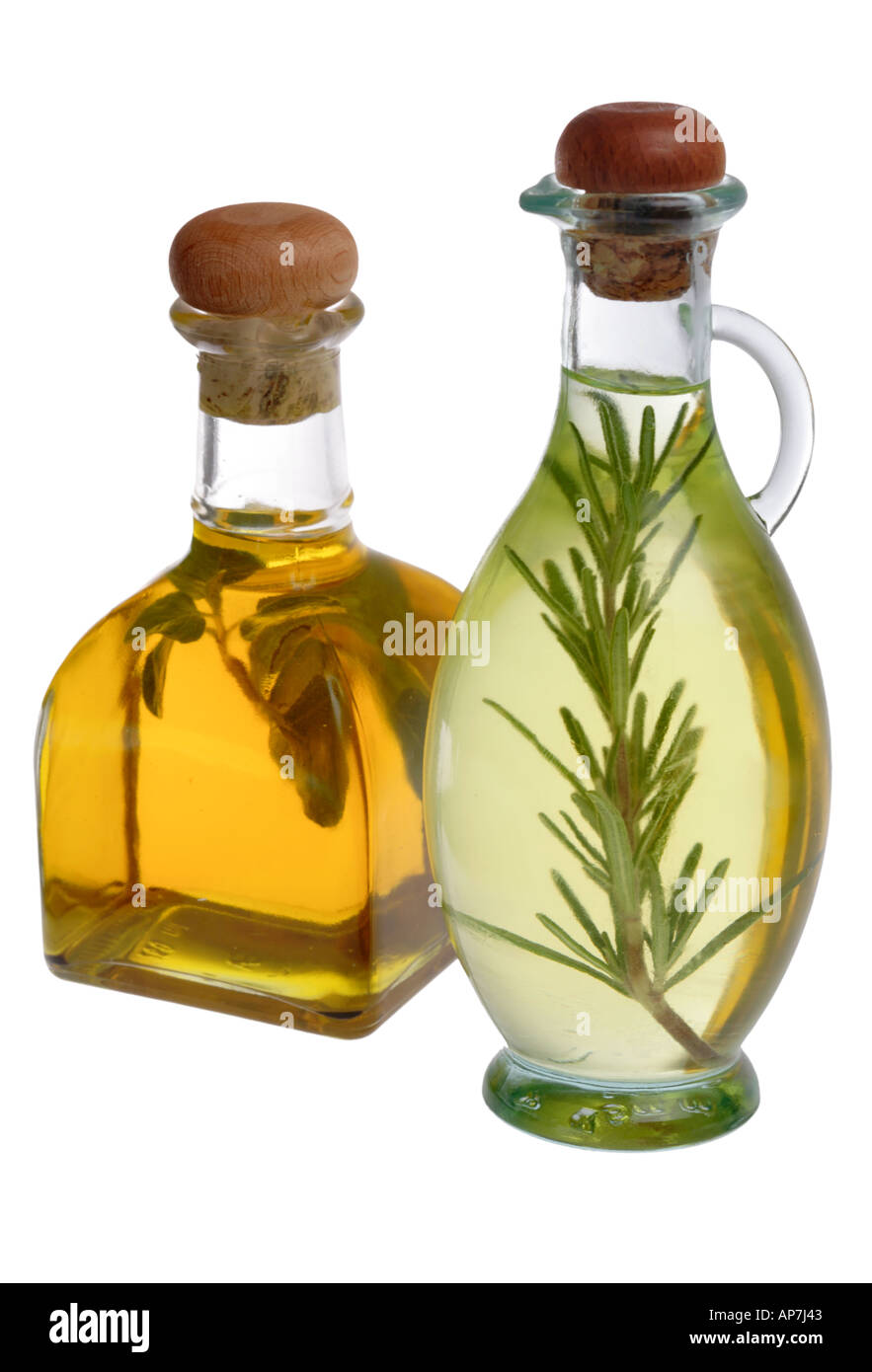 Oil and Vinegar bottles with herbs inside Stock Photo