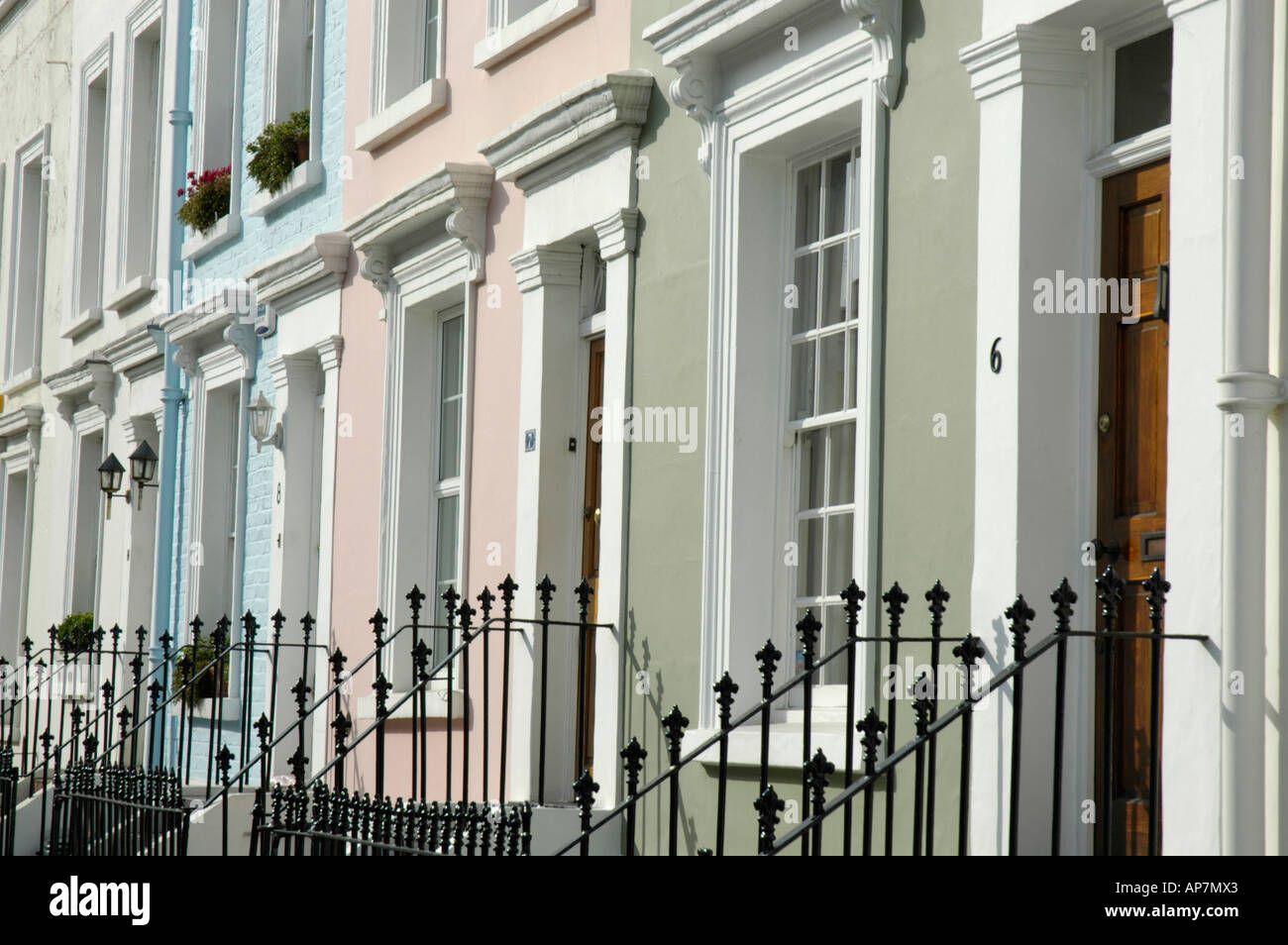 Pastel coloured painted houses in Notting Hill London England Stock